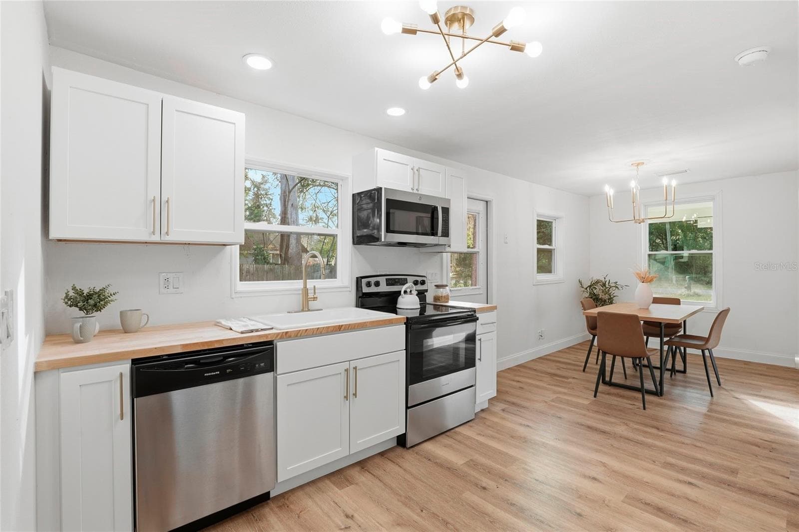 Kitchen with stainless dishwasher, open to the dining area - 425 SE 2ND ST, WILLISTON
