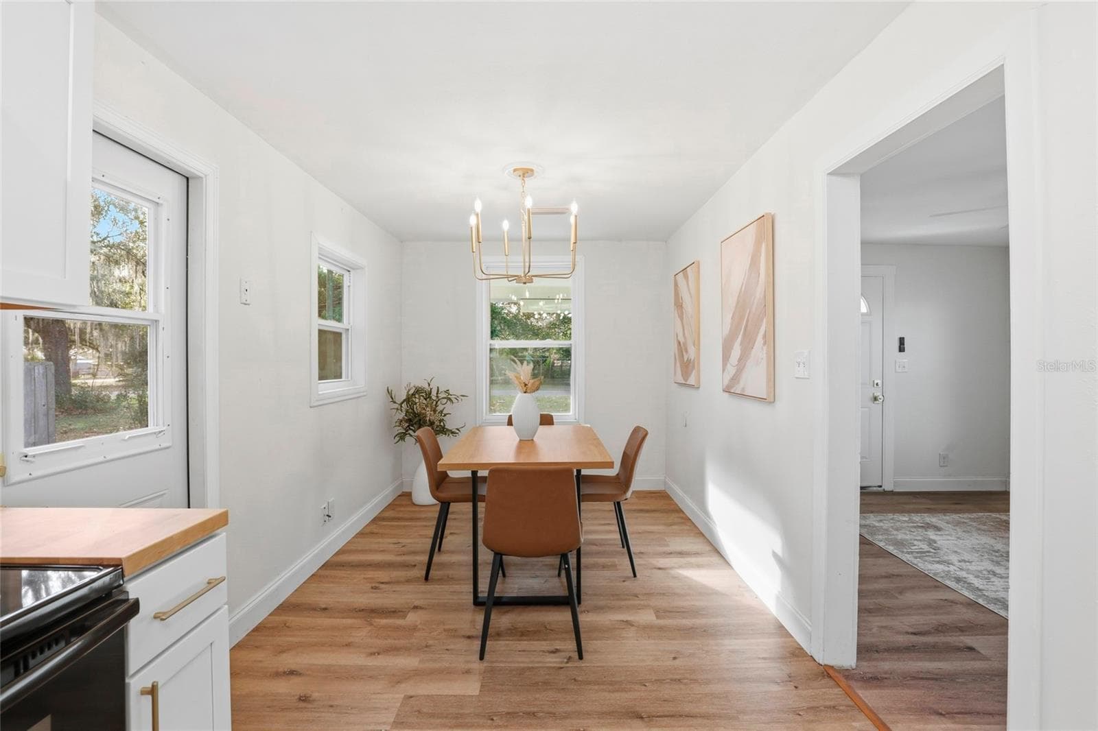 Dining area off the kitchen with chandelier and window views - 425 SE 2ND ST, WILLISTON