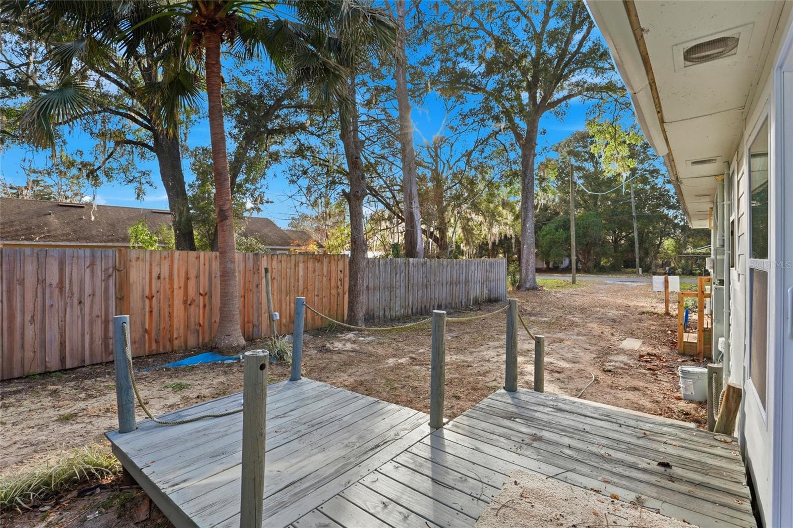 Back deck and fenced yard with mature trees - 425 SE 2ND ST, WILLISTON