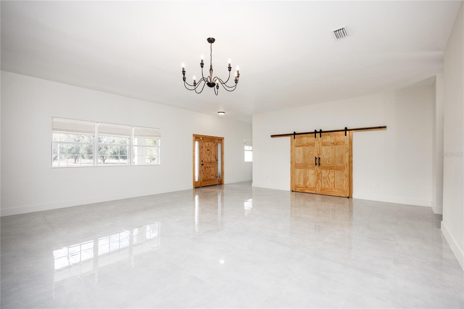 Living Room facing front door and media room doors - 12456 155TH PL, LIVE OAK