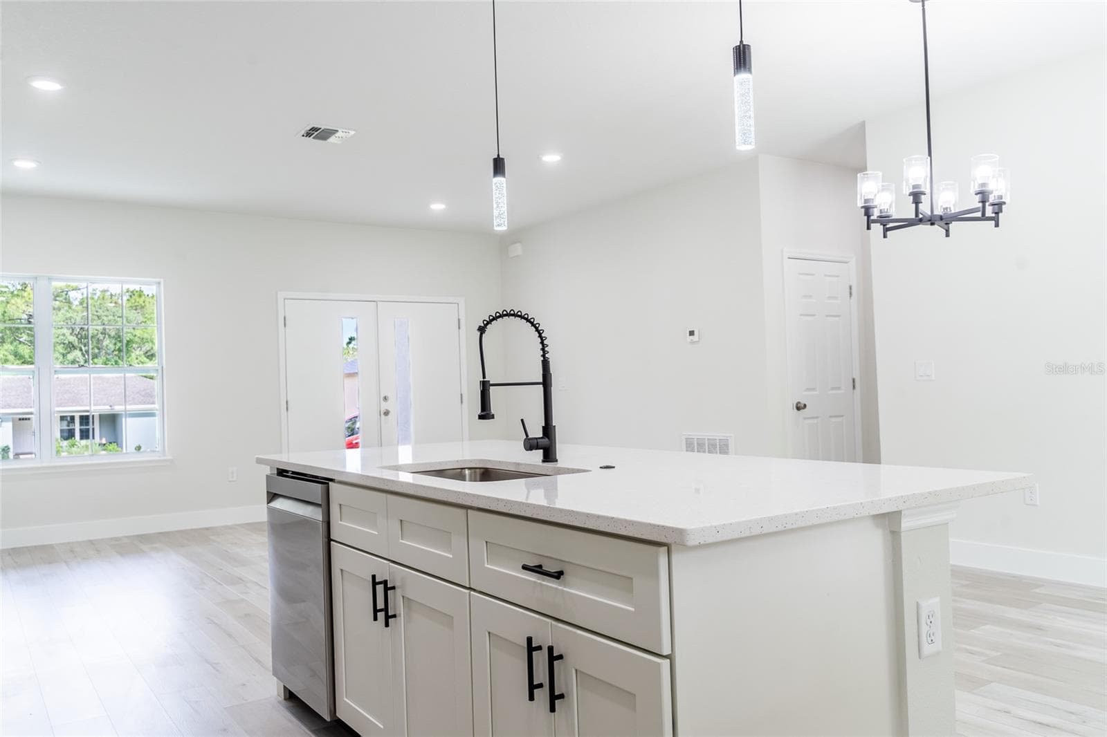 Looking across kitchen island towards front double doors - 10955 N DRAGONIS DR, CITRUS SPRINGS