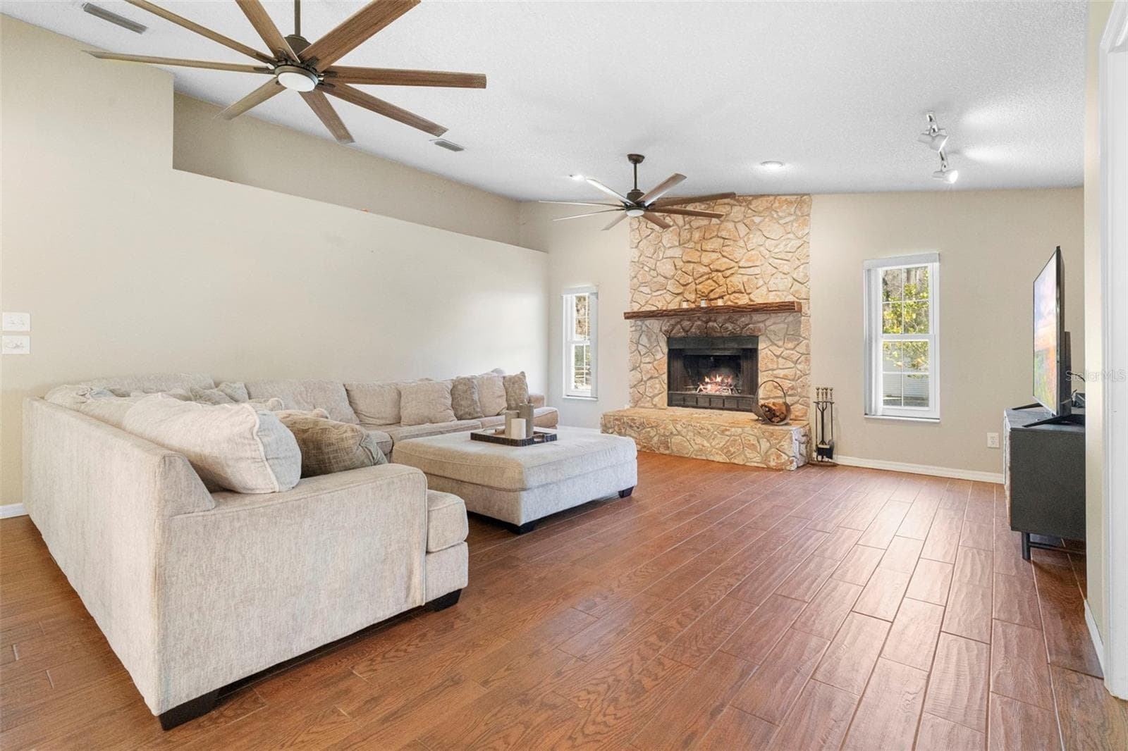 Living room with wood burning fire place - 3080 RAGIS RD, EDGEWATER
