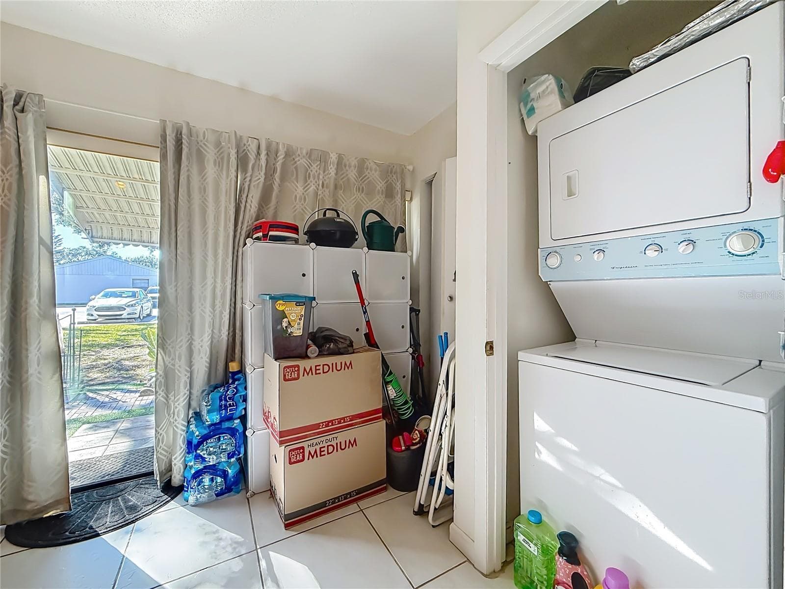 1020 85th Ave N no 119, Laundry closet, view of sliders to back patio and garden - 1020 85TH AVE N #119, ST PETERSBURG