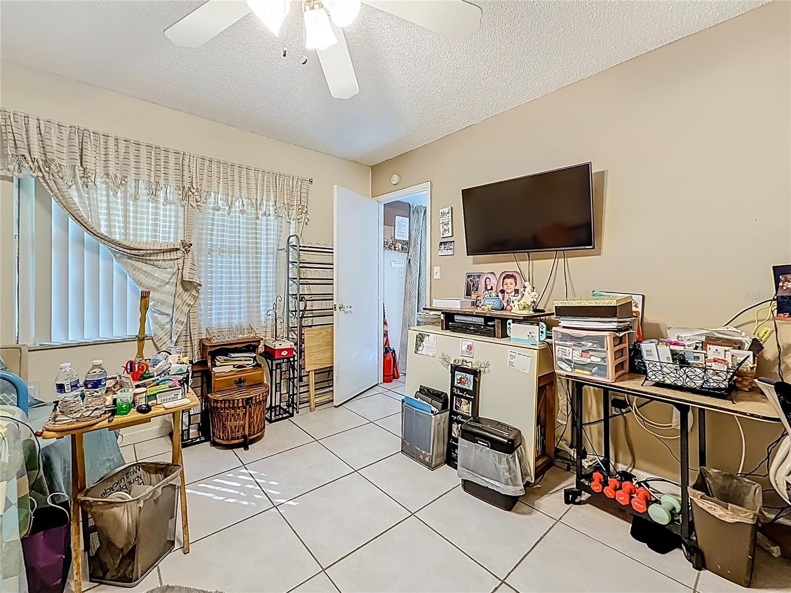 1020 85th Ave No no 119, primary bedroom, windows overlook patio and garden - 1020 85TH AVE N #119, ST PETERSBURG