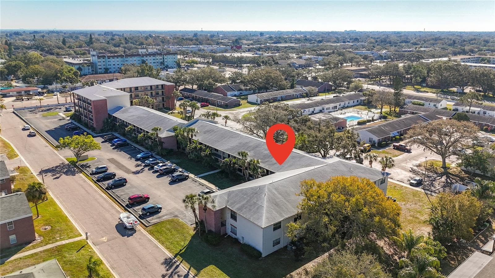 1020 85th Ave N no 119, view toward southeast, community pool, clubhouse at back of unit. Gateway shopping center in background - 1020 85TH AVE N #119, ST PETERSBURG