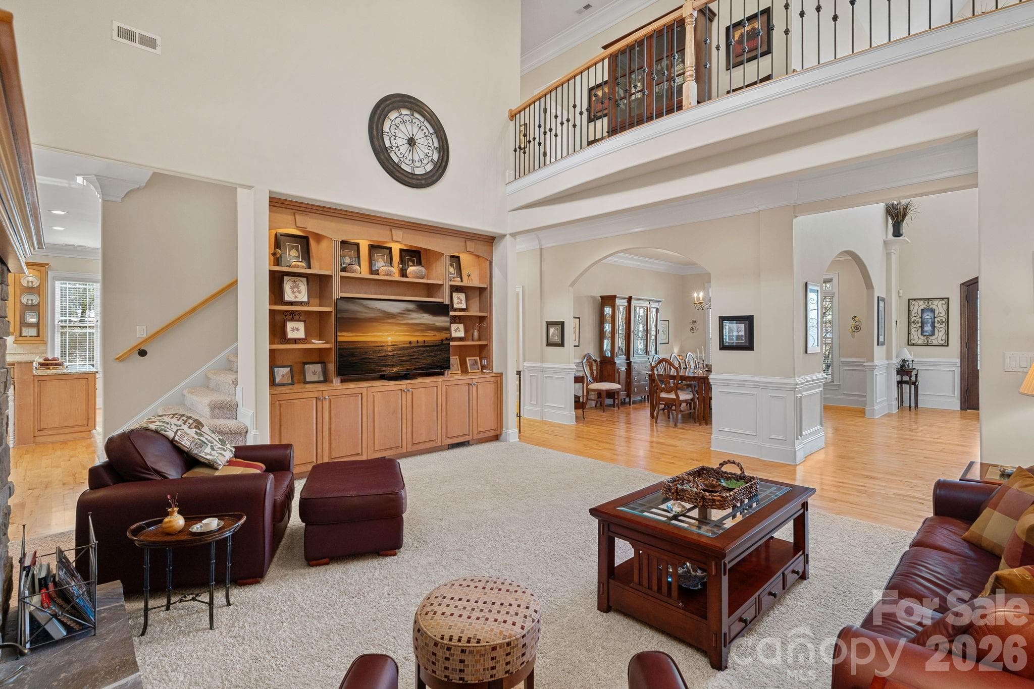 Spacious living room with vaulted ceilings, stone fireplace, and custom built-ins. - Denver