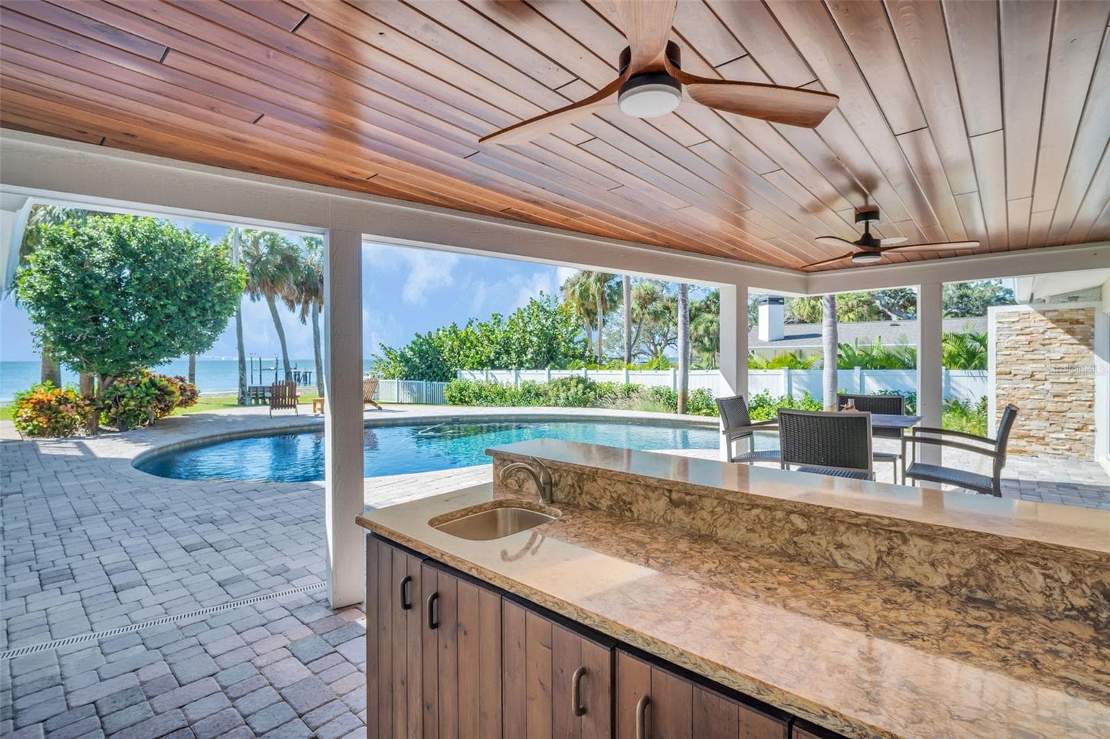 Covered patio, bar area and pass through with wood finished ceiling treatments - 1100 FRIENDLY WAY S, ST PETERSBURG