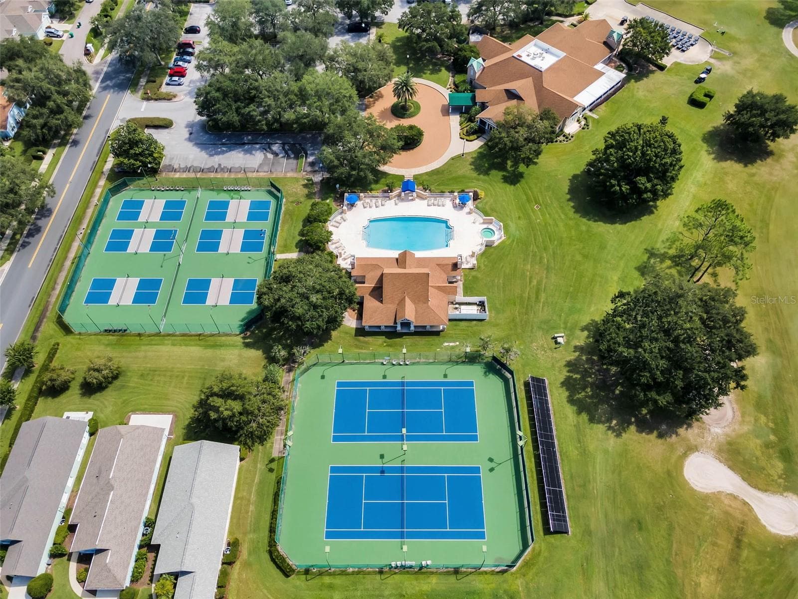 Aerial view of pool and courts - 8032 PINE HOLLOW DR, MOUNT DORA