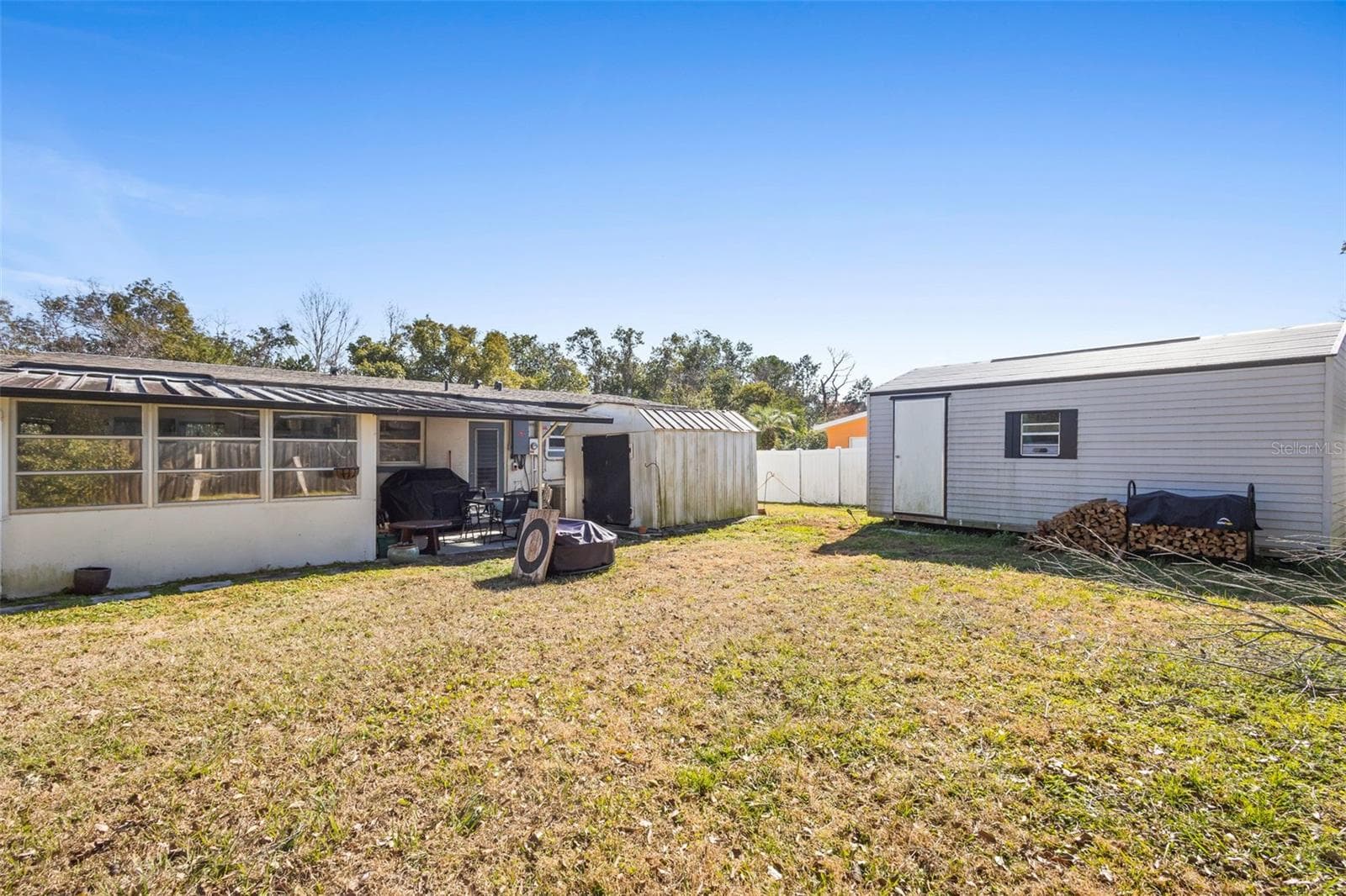 View of property, and sheds. - 1552 ZINNIA DR, DELTONA
