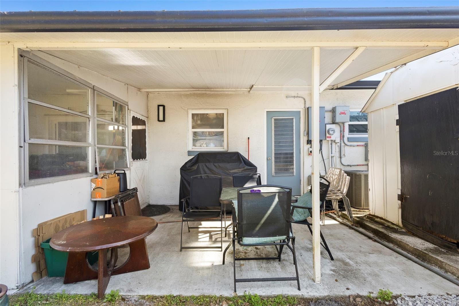 View of outside of patio, entrance of laundry room with shed for storage. - 1552 ZINNIA DR, DELTONA