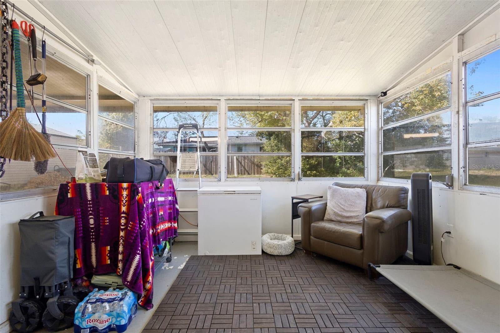 View of patio with large windows. - 1552 ZINNIA DR, DELTONA