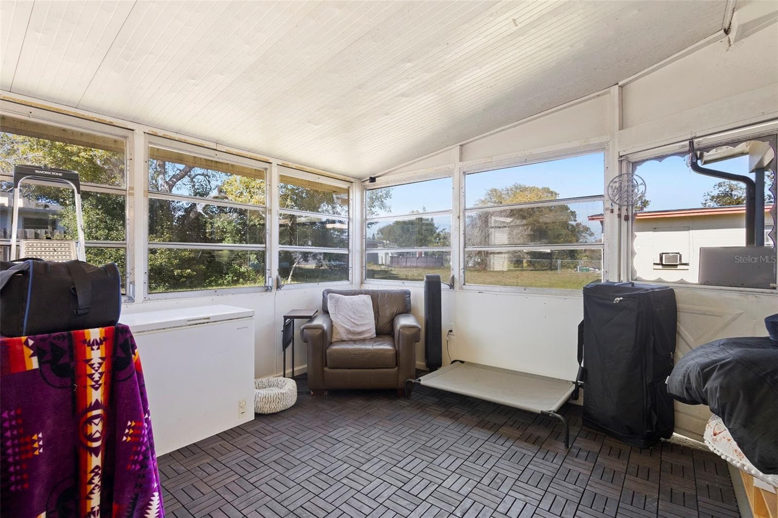 View of enclosed patio from dining area. - 1552 ZINNIA DR, DELTONA
