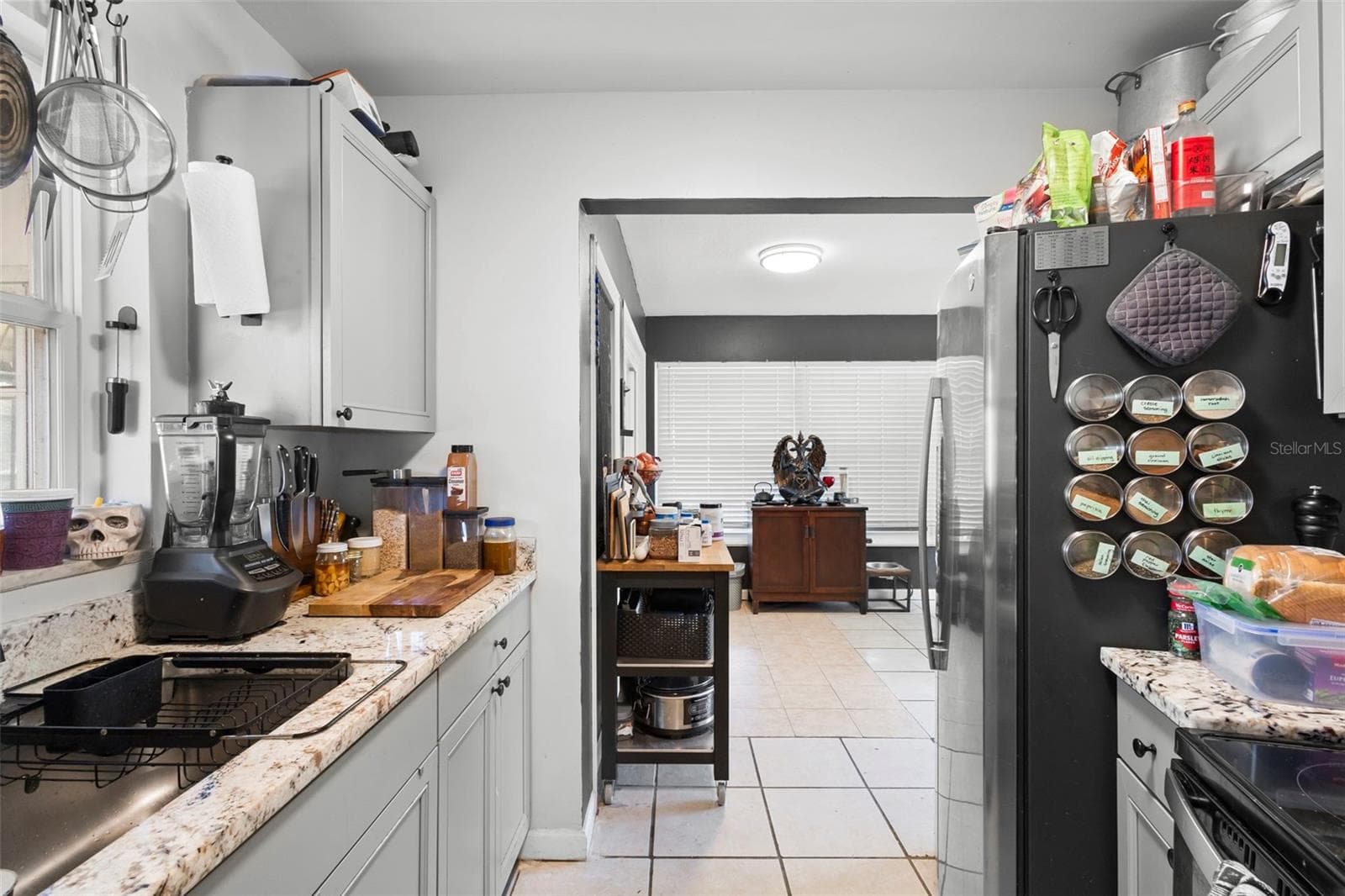 View of kitchen toward dining area. - 1552 ZINNIA DR, DELTONA
