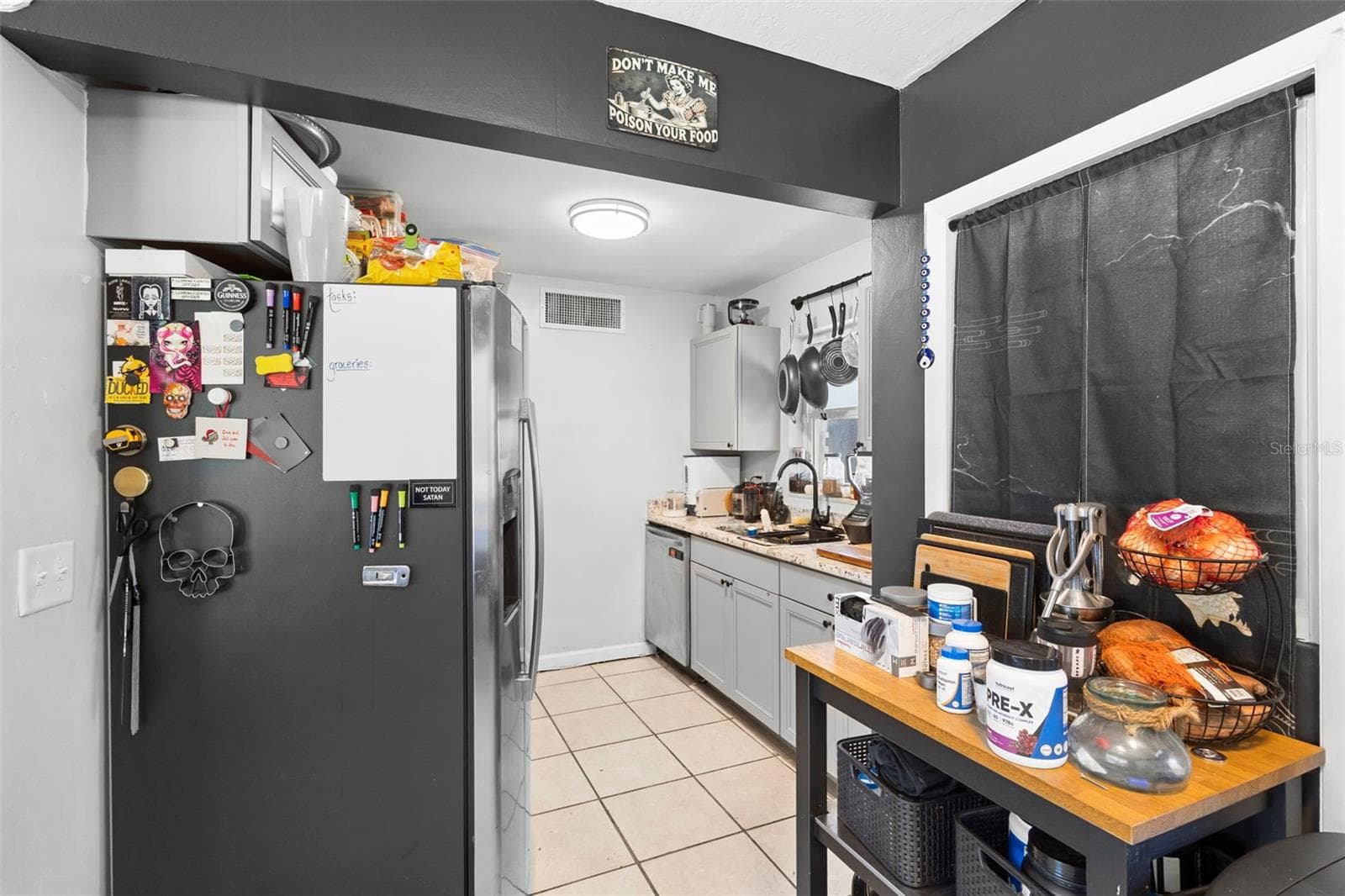 View of kitchen, with stainless steel appliances. - 1552 ZINNIA DR, DELTONA