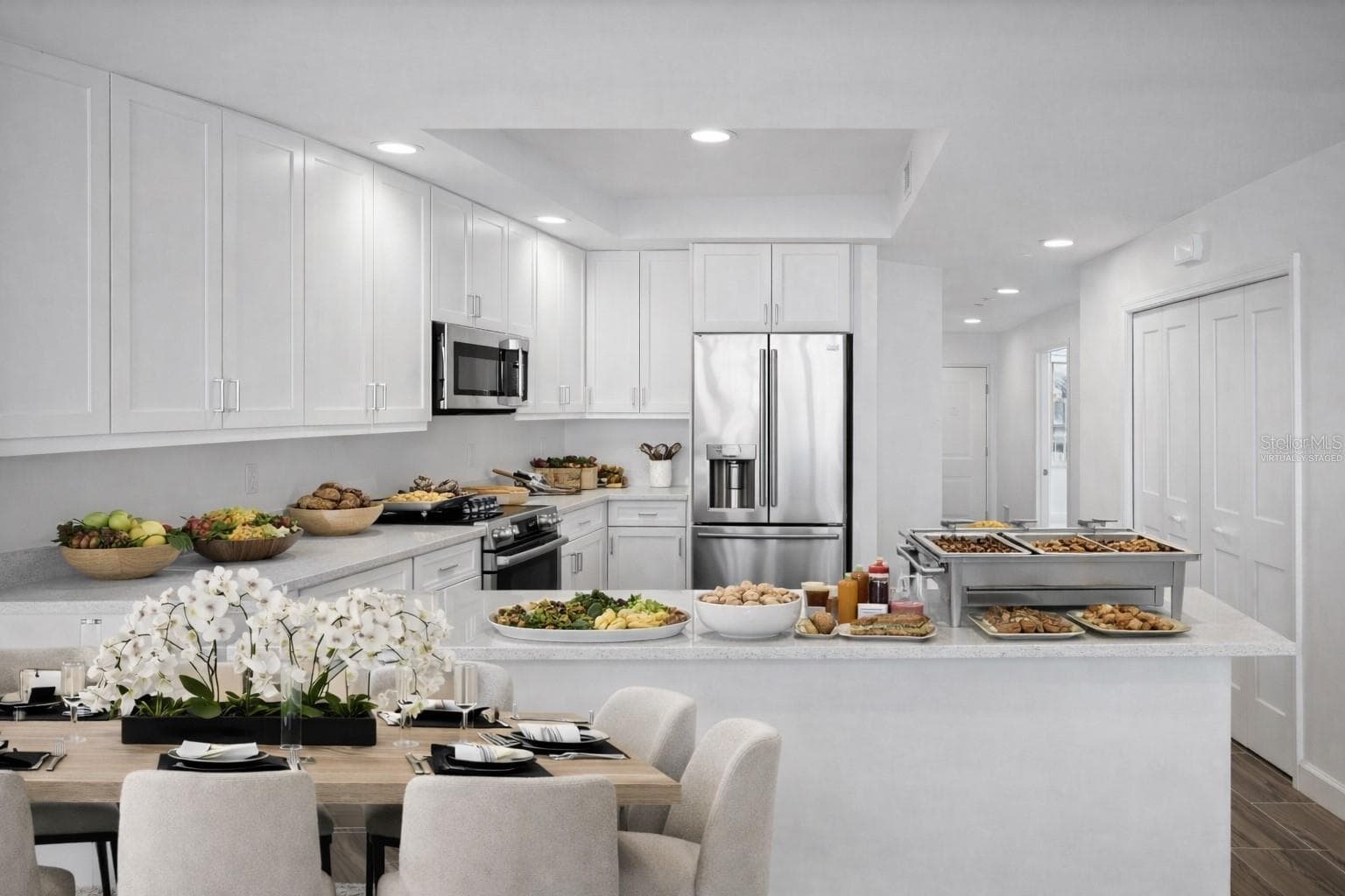 Virtually staged dining area in front of kitchen counter - 125 ISLAND WAY #304, CLEARWATER BEACH