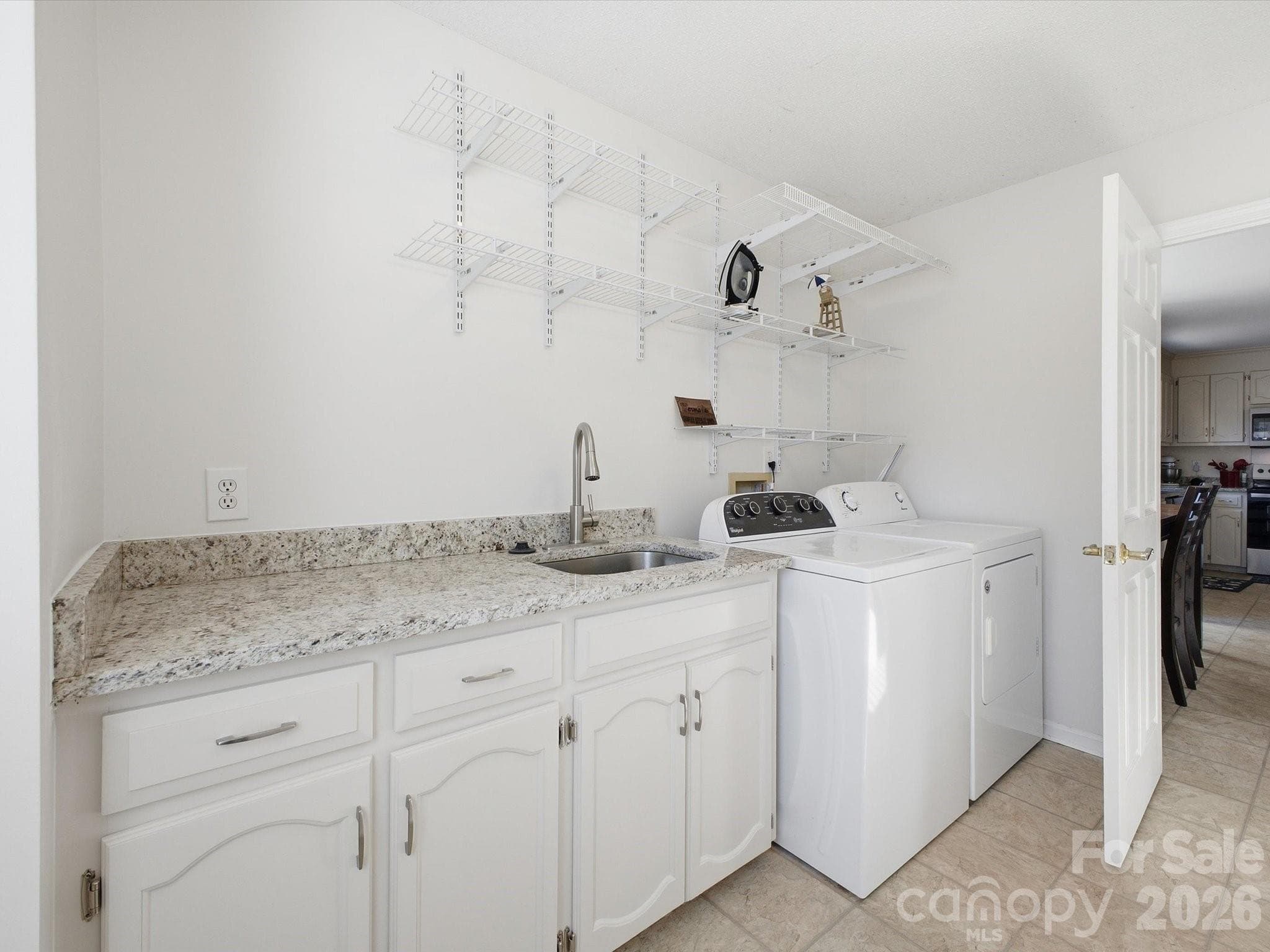 Spacious Laundry room with additional storage and mud sink on main floor - 109 Elk Court, Mount Holly