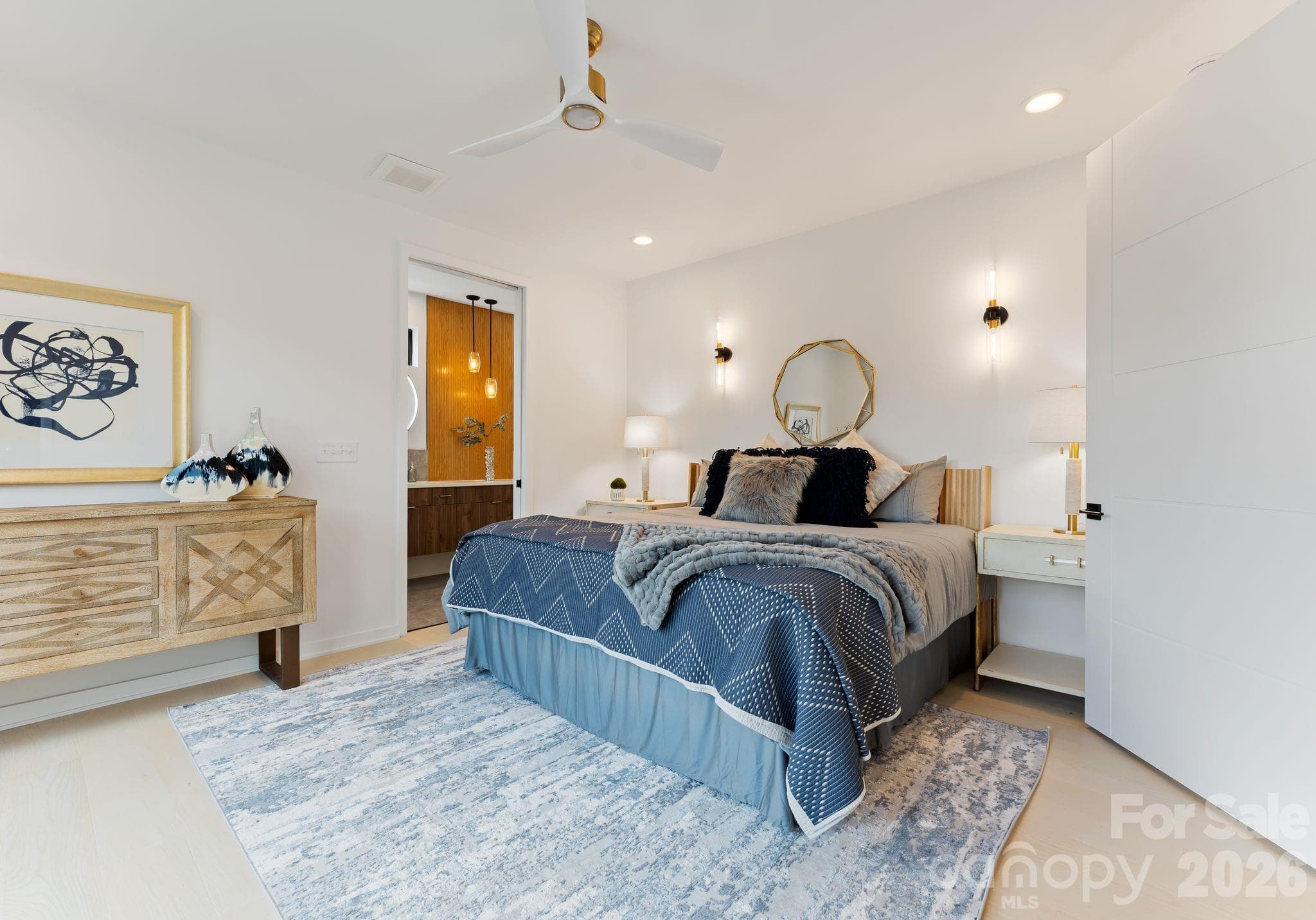 Primary bedroom with sconce lighting. - Charlotte
