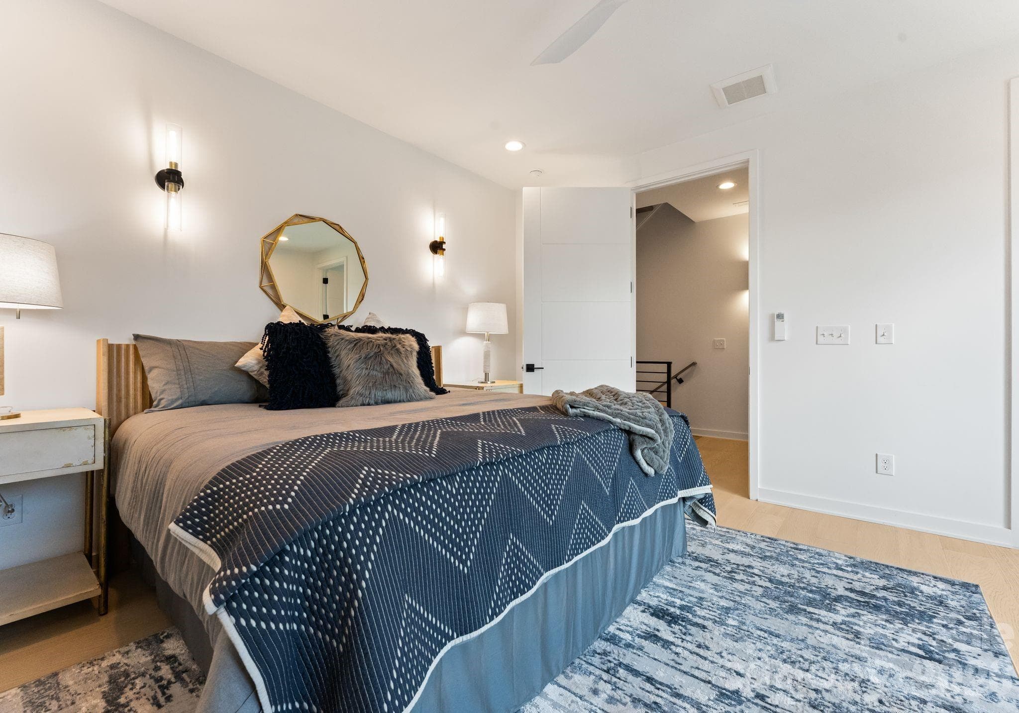 Primary bedroom with sconce lighting. - Charlotte