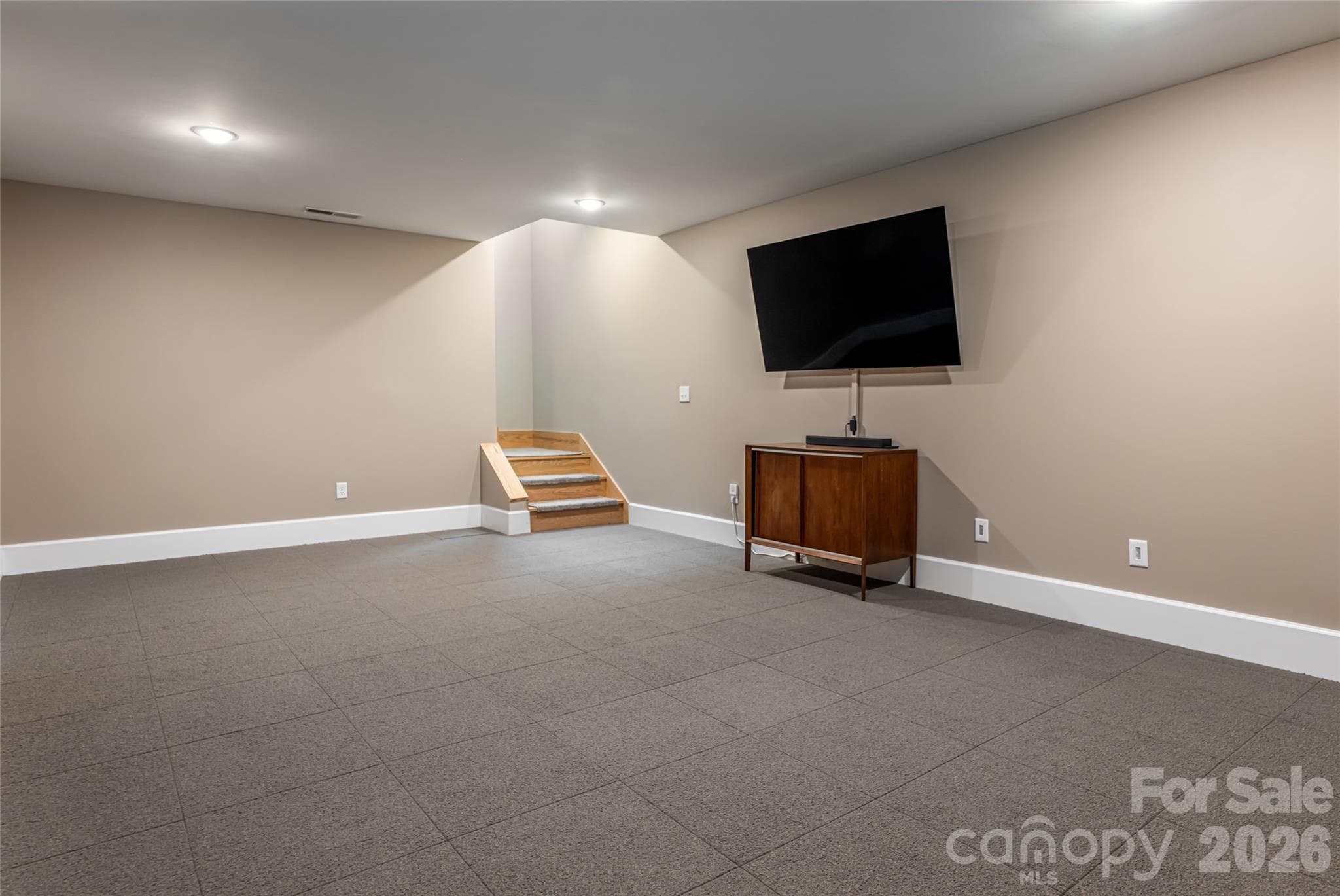 Bonus room in basement with removable carpet (finished concrete under carpet squares) - 7 Bee Balm Way, Asheville