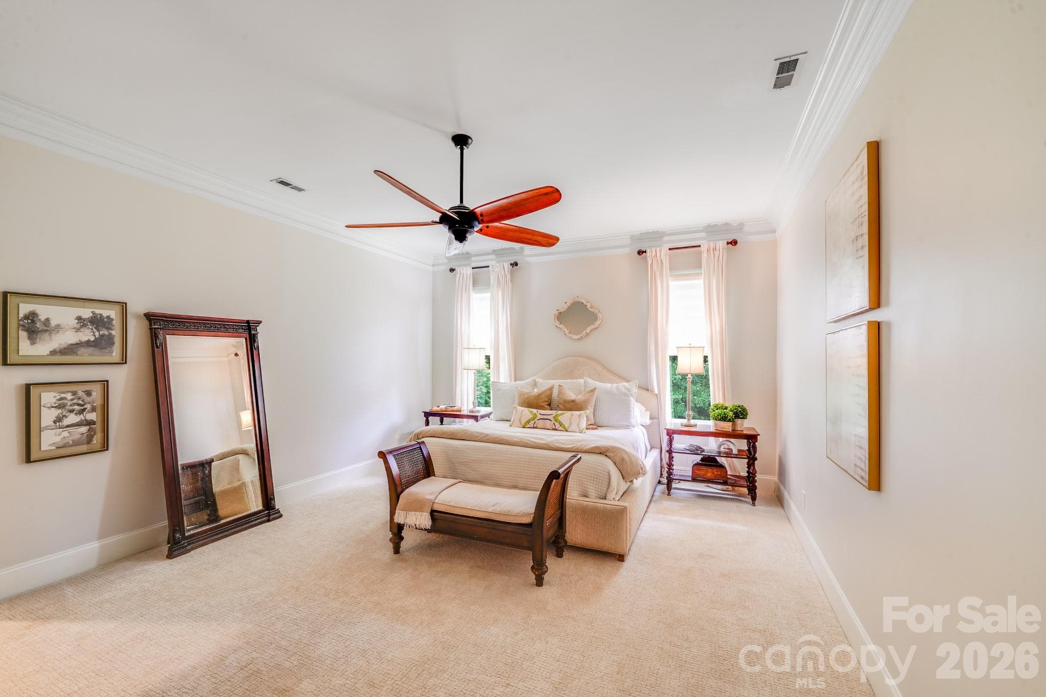 Primary bedroom features neutral tones, crown molding, and plush wall-to-wall carpeting - 2702 Arsdale Road, Waxhaw