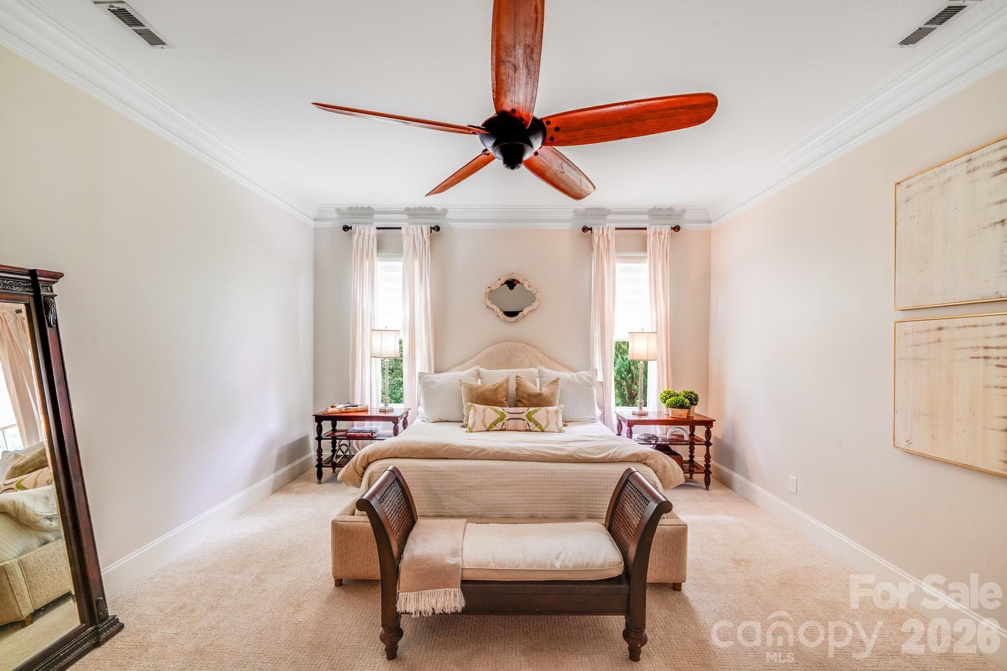 Oversized layout with room for a sitting area or bench at the foot of the bed, two tall windows flanking the bed, and large ceiling fan with wooden blades - 2702 Arsdale Road, Waxhaw