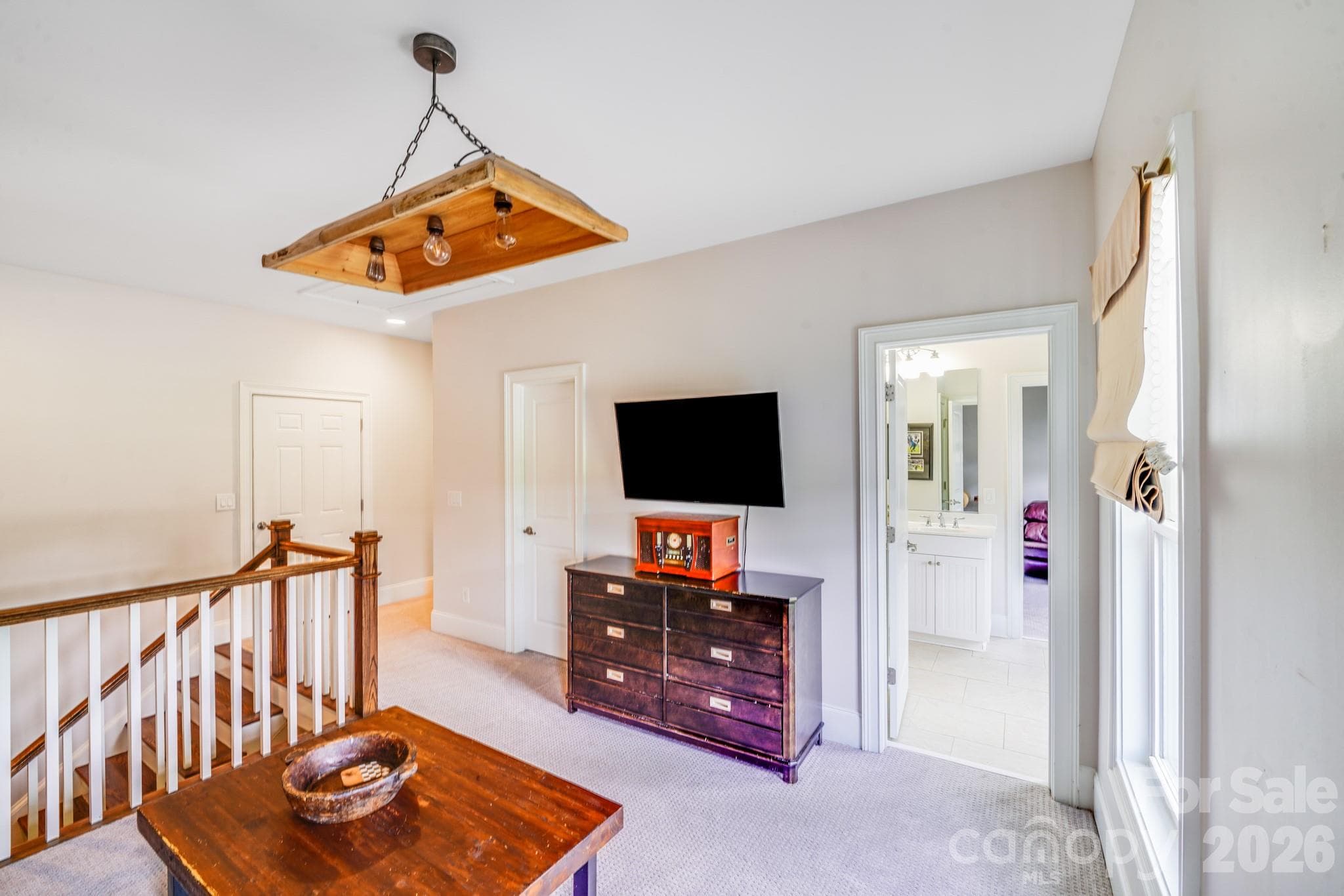 This final view of the second-floor loft highlights its practical layout and proximity to secondary bedrooms and a full bath - 2702 Arsdale Road, Waxhaw