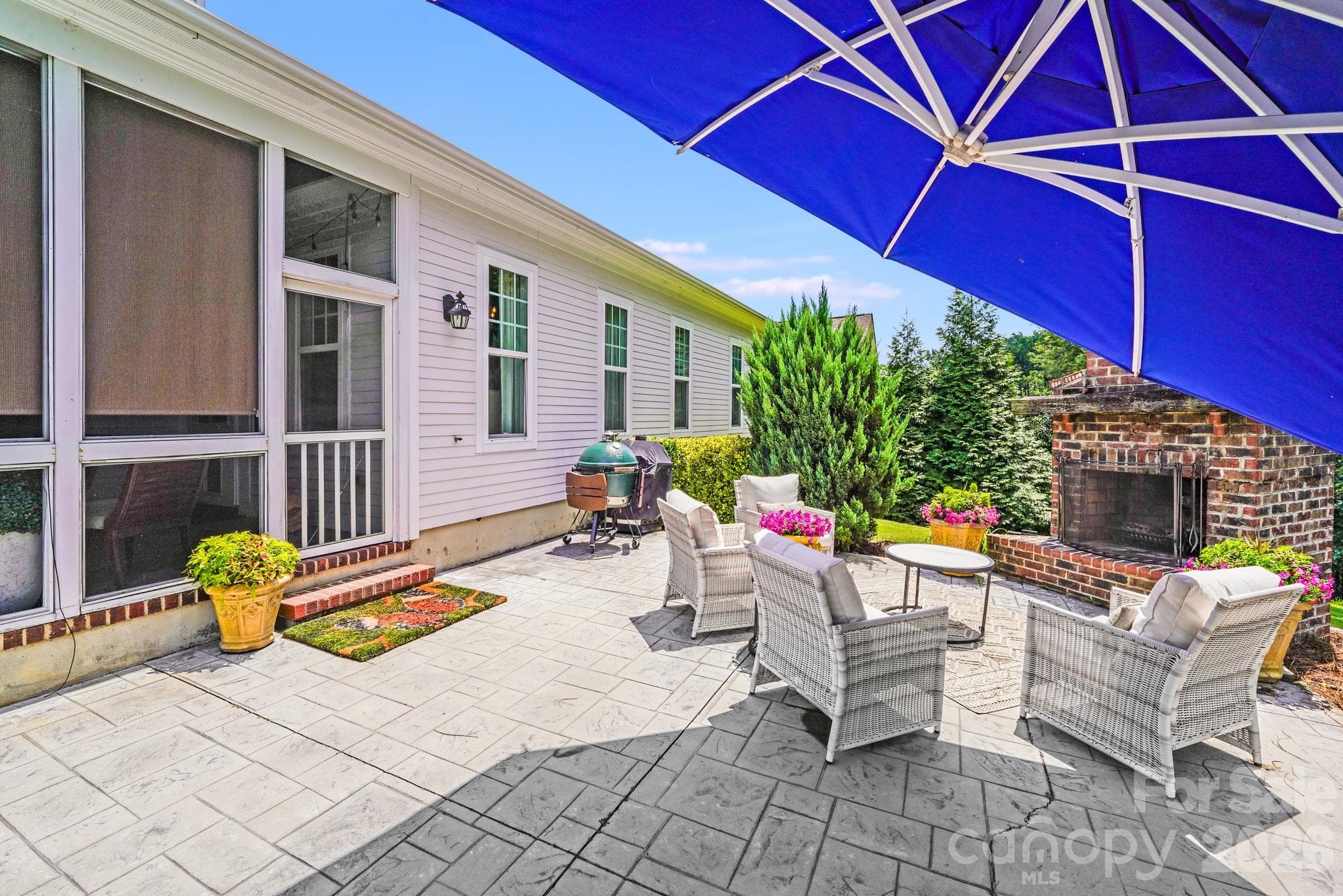 Seamless flow between the screened porch and patio, with lush landscaping providing privacy - 2702 Arsdale Road, Waxhaw