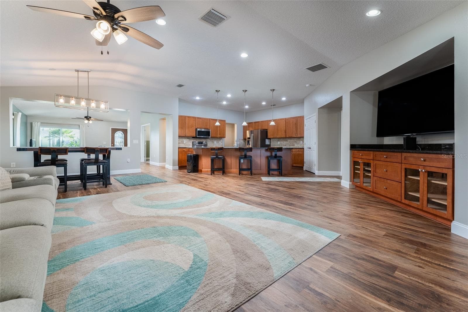 View of family room, kitchen and dining area from the sliders that go to pool - 5431 SANDY SHELL DR, APOLLO BEACH