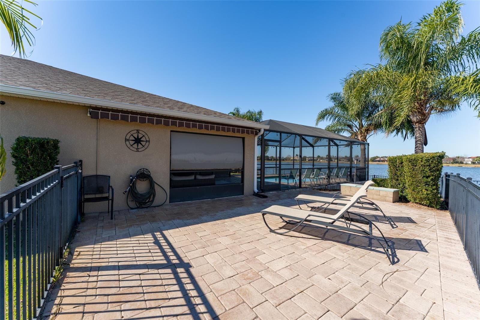 Side patio with motorized awning for shade - 5431 SANDY SHELL DR, APOLLO BEACH