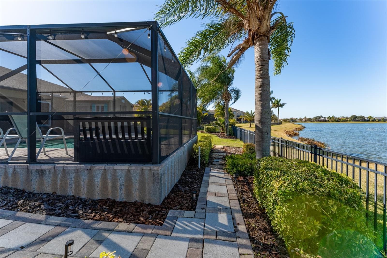 Brick walk way goes around pool - 5431 SANDY SHELL DR, APOLLO BEACH