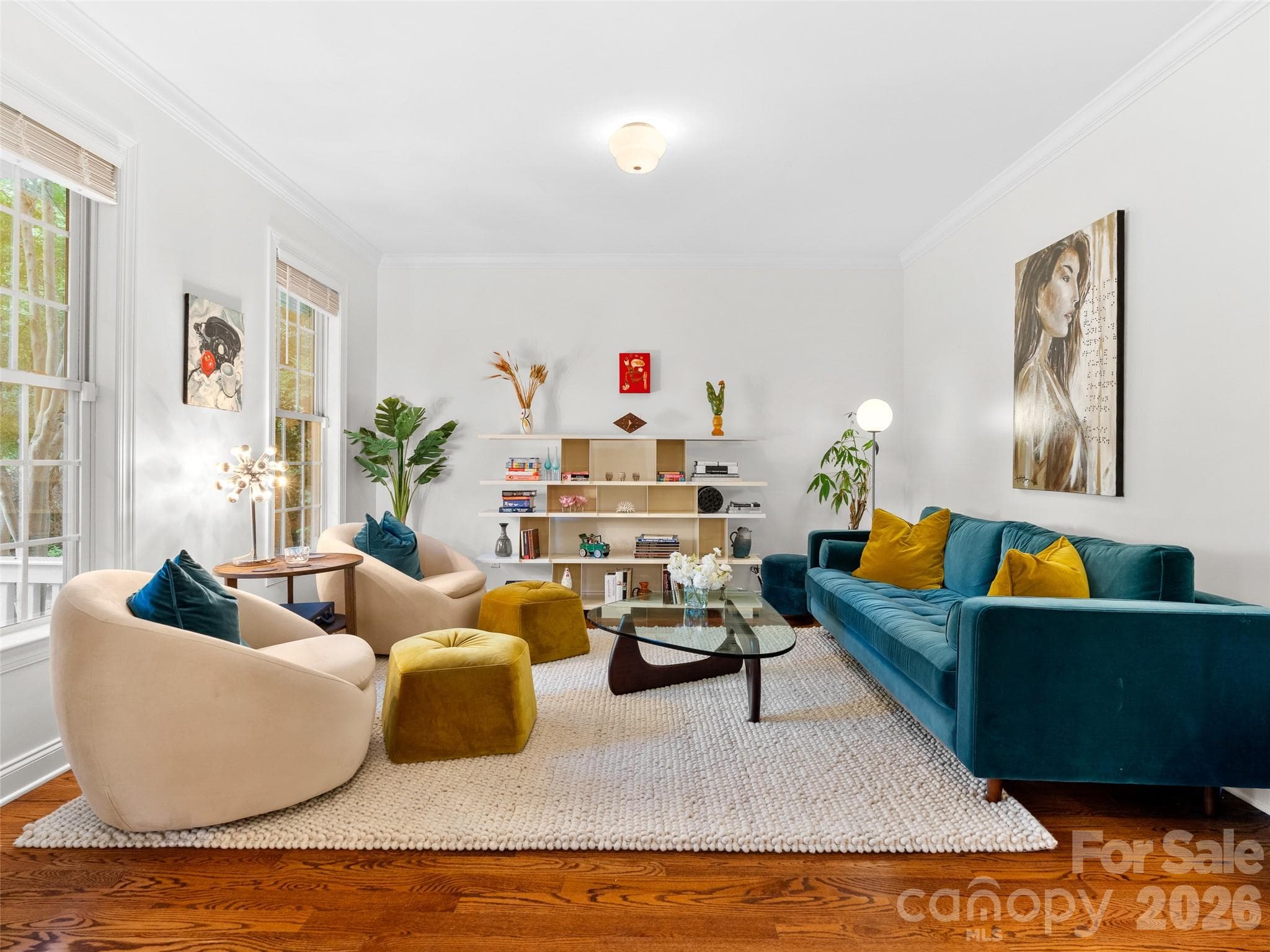 The living room showcases rich hardwood floors complemented by natural light, creating a warm and welcoming space for everyday living. - Asheville