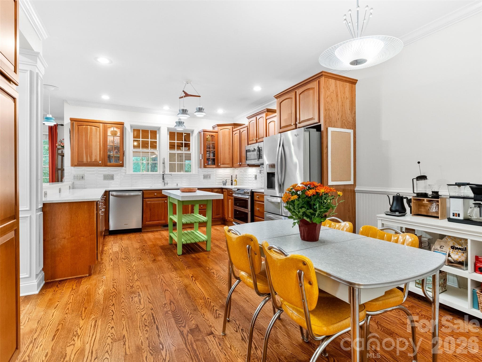 Enjoy the seamless flow of this open space, where the eat-in area and the thoughtfully designed kitchen combine for effortless everyday living and entertaining. - Asheville