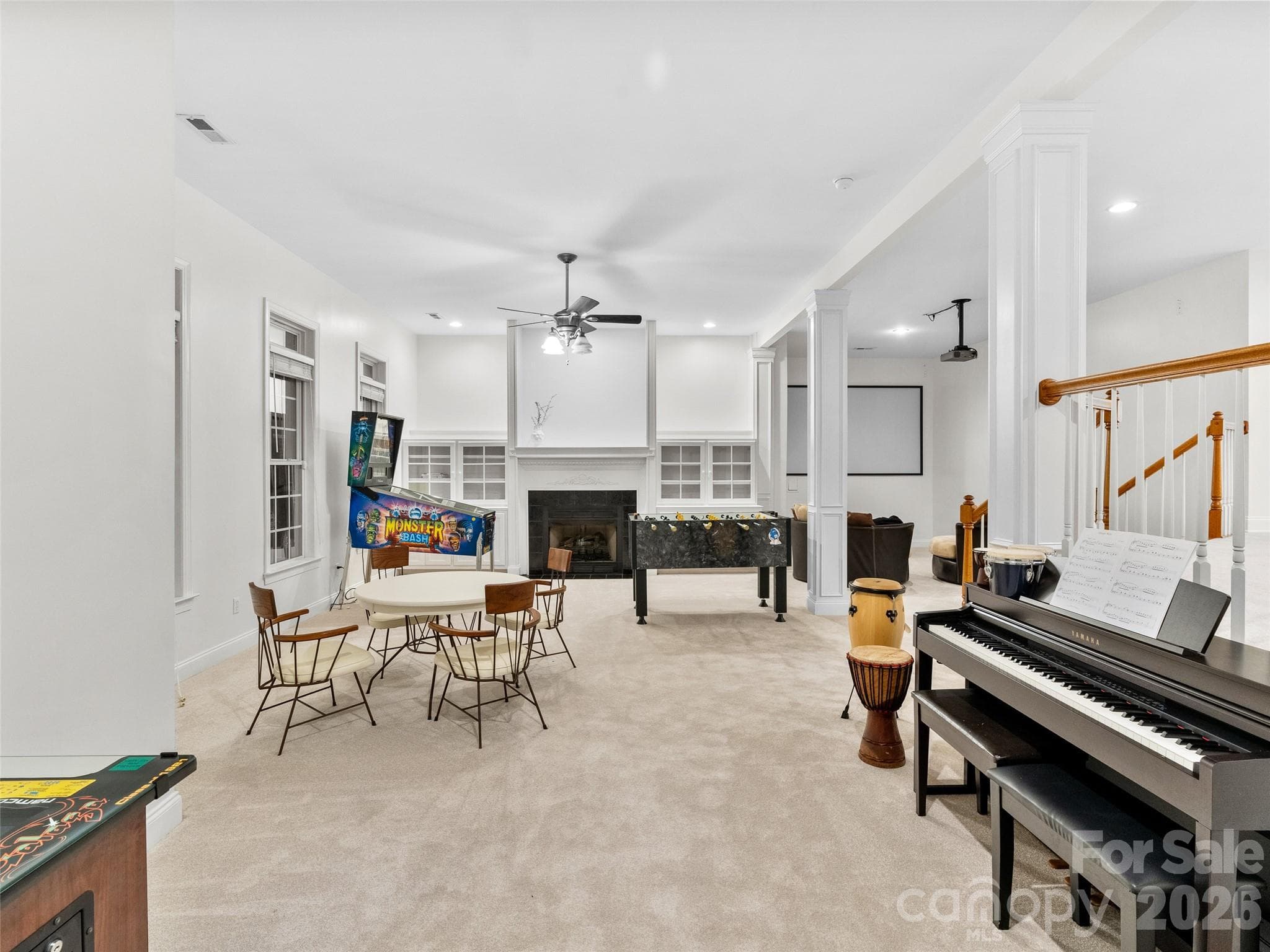 Spacious lower-level rec room with carpet, built-ins surrounding the fireplace, movie area, glass doors to the side yard and your very own Reiki room. - Asheville