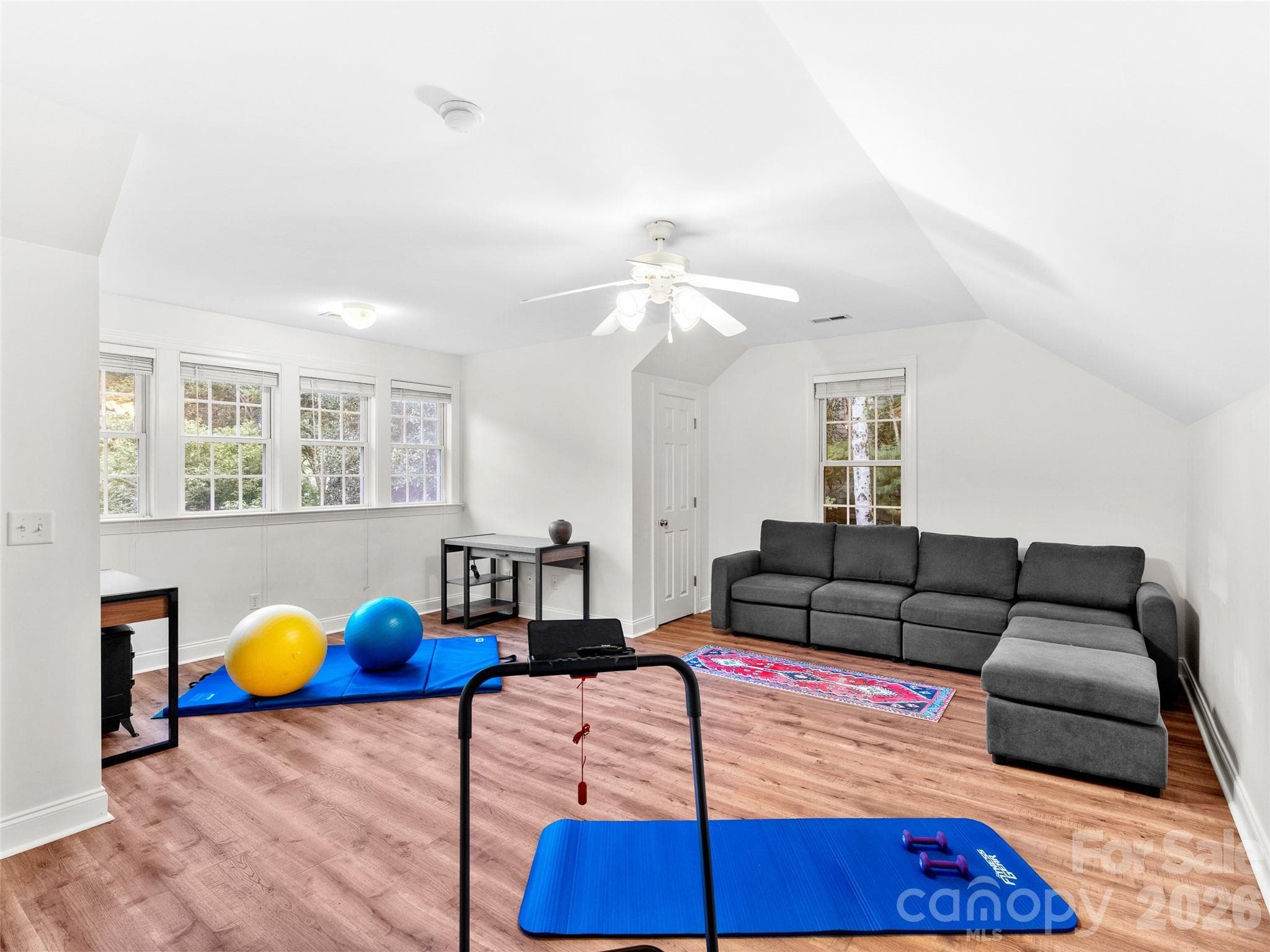 Whether used as a home gym, studio or creative space, this bonus room offers hardwood floors and sun-dappled windows, creating an inviting and energizing environment. - Asheville