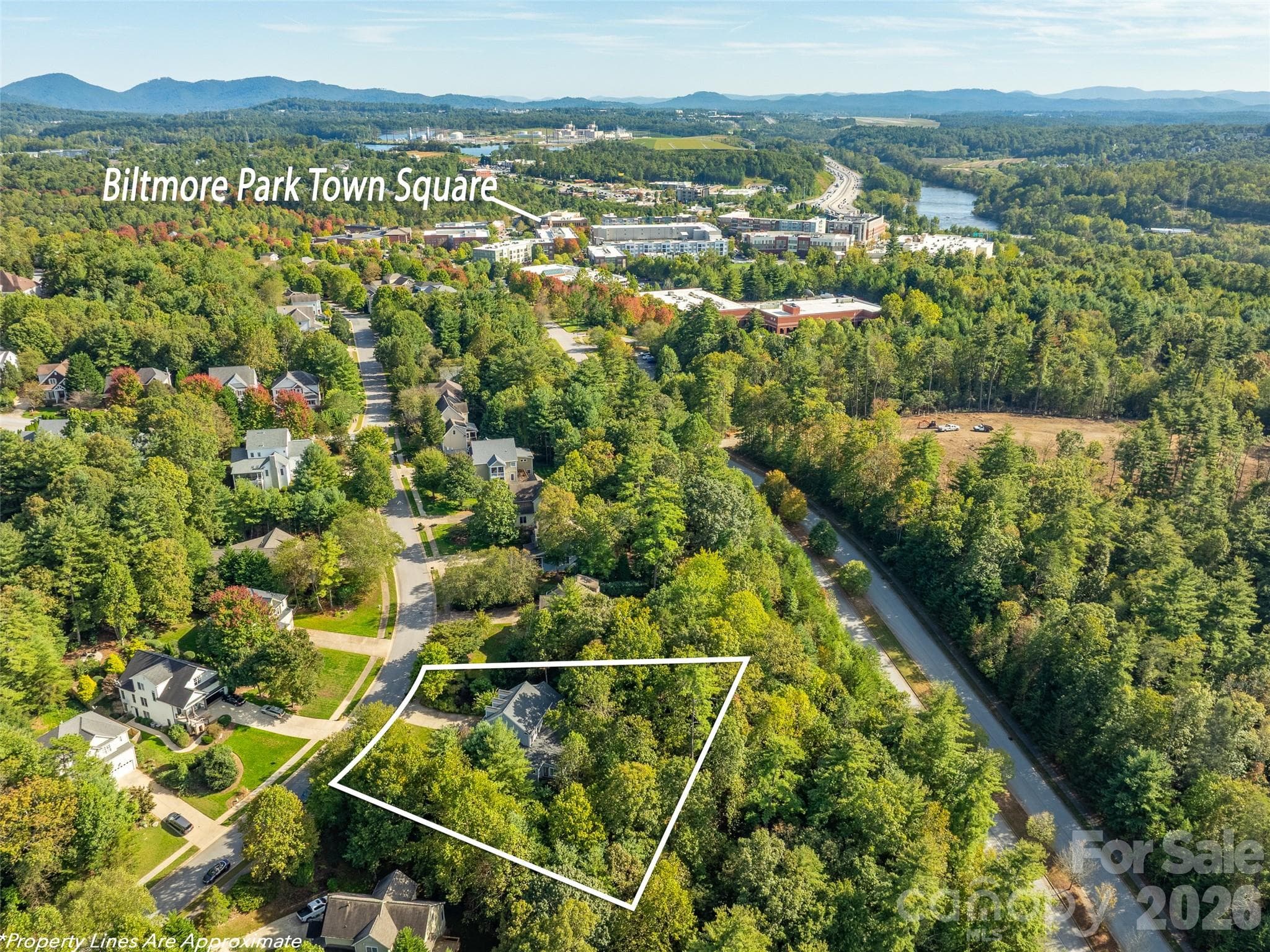 This aerial view showcases the home's close proximity to Biltmore Park Town Square, just minutes from a vibrant mix of restaurants, shops, and entertainment. - Asheville