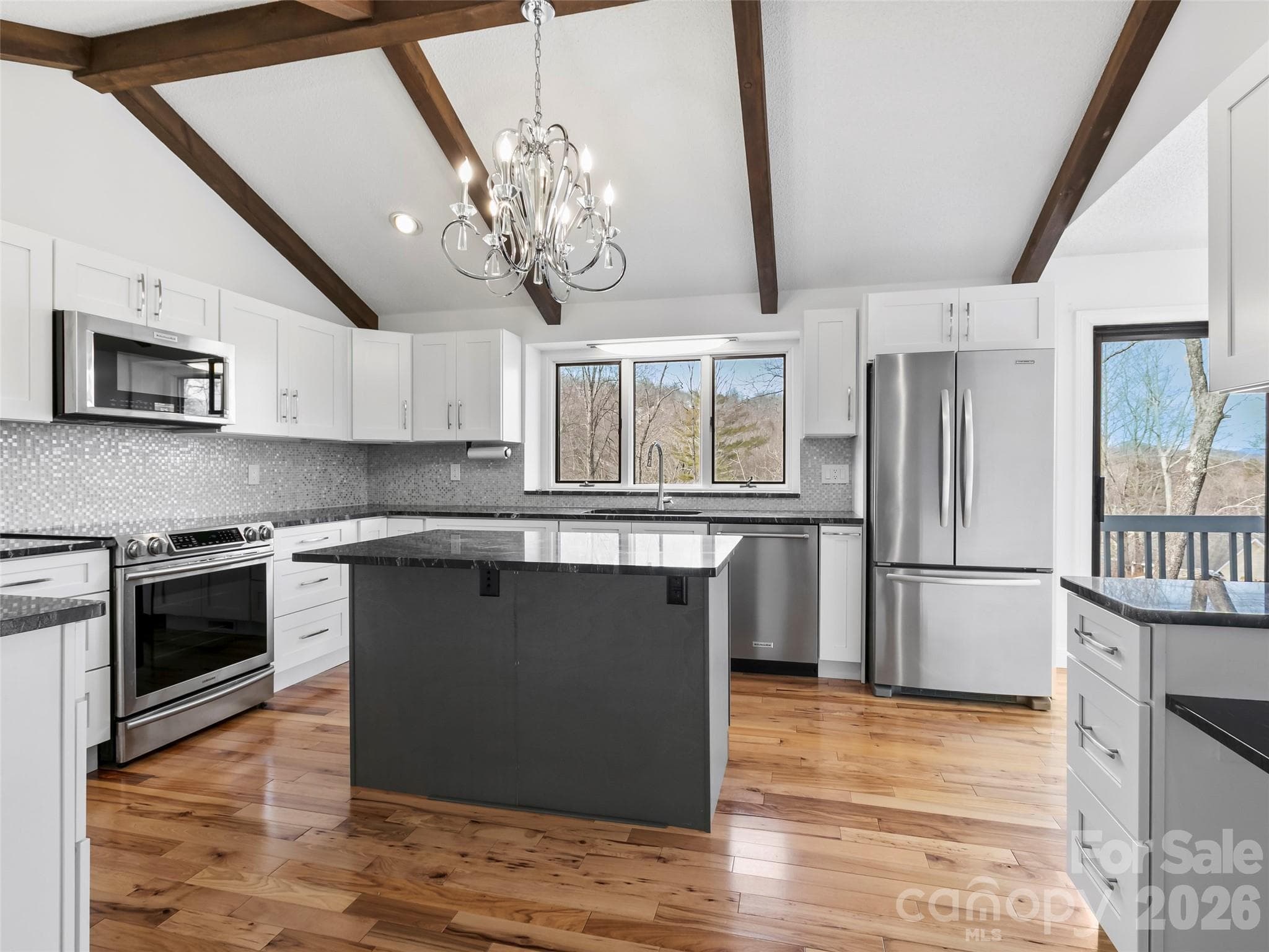 A beautifully updated kitchen features generous workspace, modern finishes, and a functional layout. - 2731 Miller Lane, Hendersonville