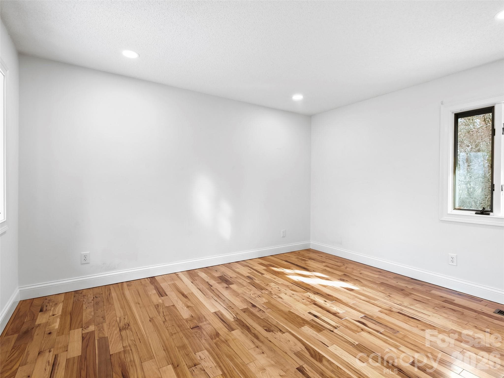 Bedroom 2 is privately situated on the main level, offering comfort and convenience for guests or family members. - 2731 Miller Lane, Hendersonville