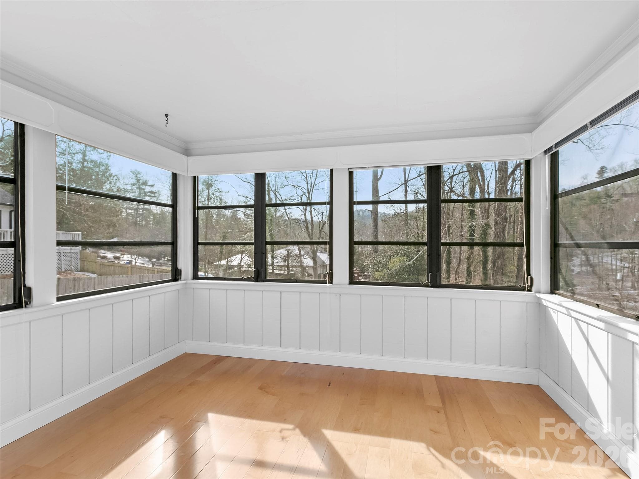 The charming all-season room features expansive windows that showcase the beauty of every season while creating a comfortable indoor-outdoor connection. - 2731 Miller Lane, Hendersonville