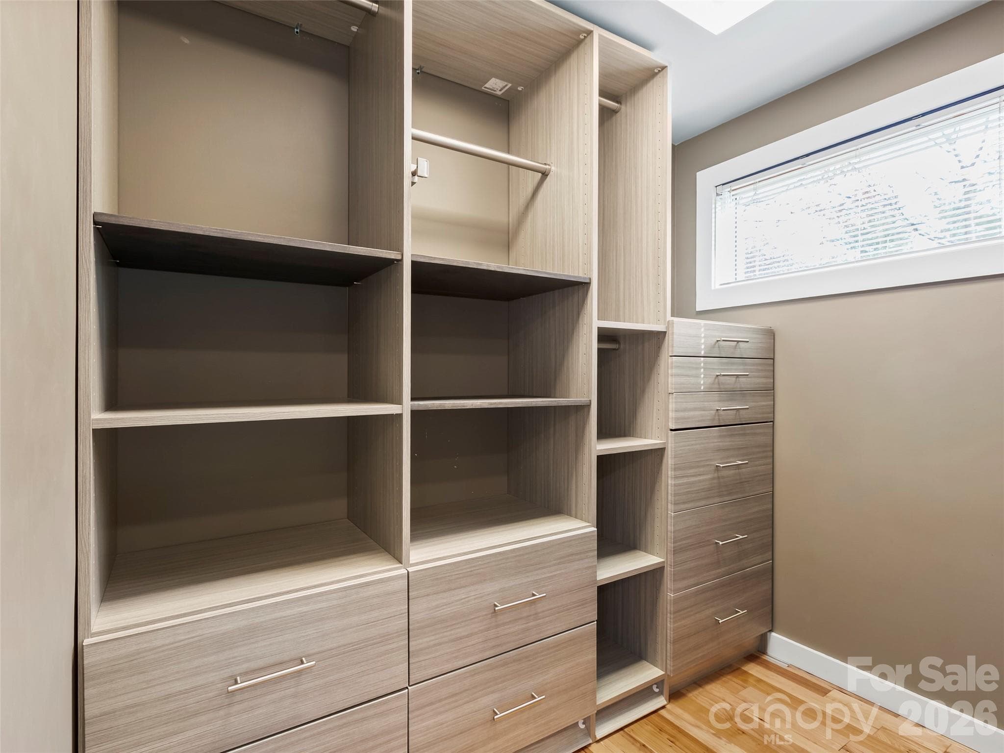 The primary suite features two separate closets, each with custom shelving to provide exceptional organization and storage. - 2731 Miller Lane, Hendersonville