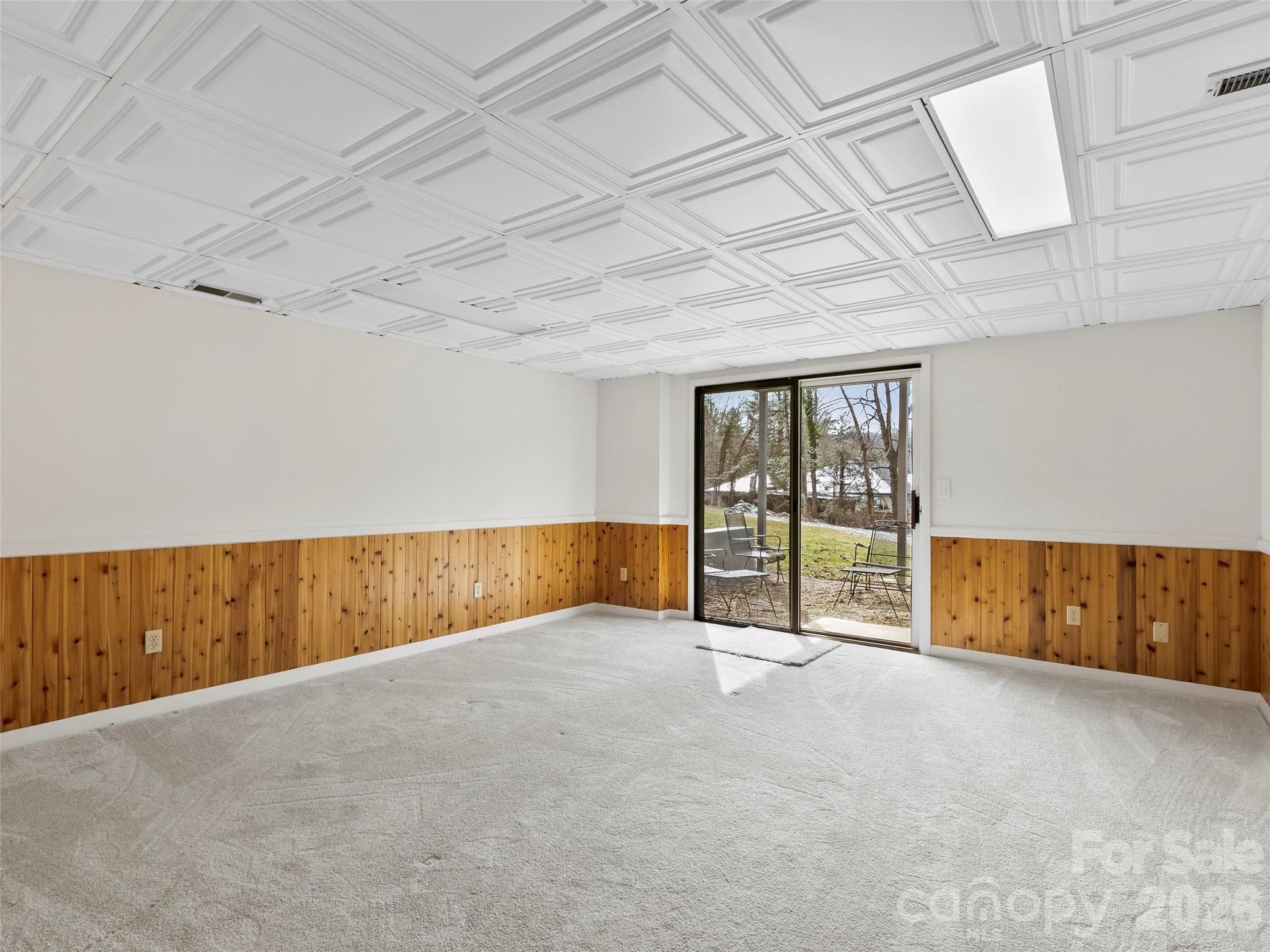 Bedroom 3 on the lower level offers privacy and direct access to the outdoor patio, perfect for guests or a private retreat. - 2731 Miller Lane, Hendersonville