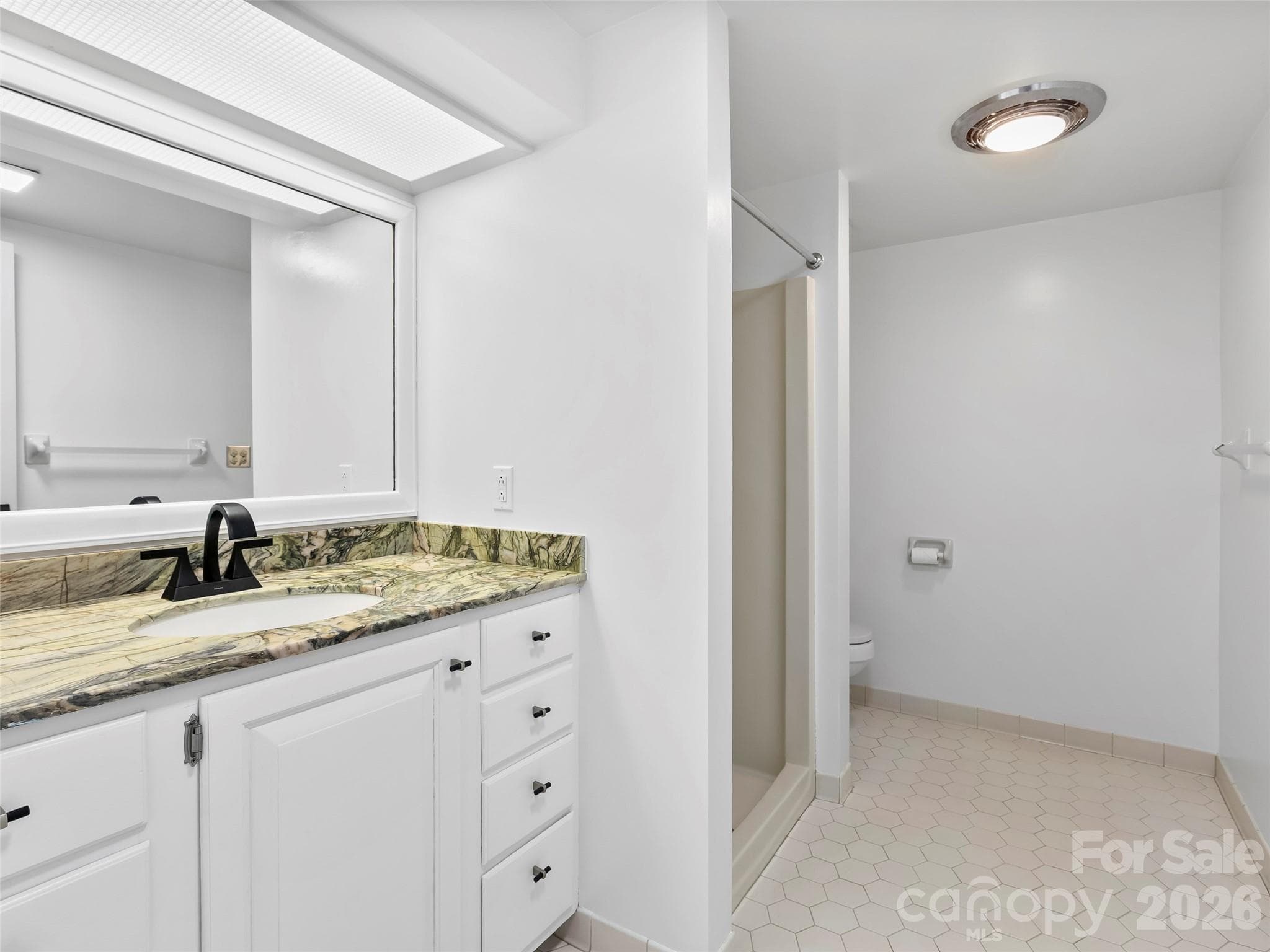 The freshly painted lower-level full bathroom offers a clean, updated feel and added convenience for guests or family members. - 2731 Miller Lane, Hendersonville
