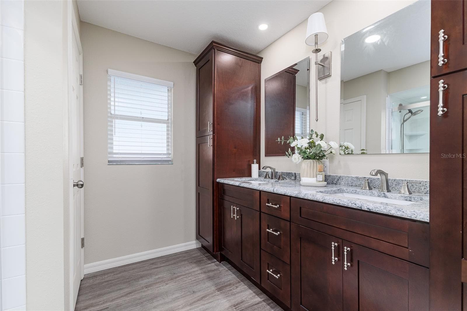 En Suite Primary Bath with dual sinks, stone countertops, plenty of storage, and great lighting - 411 EDGEWATER DR, POLK CITY