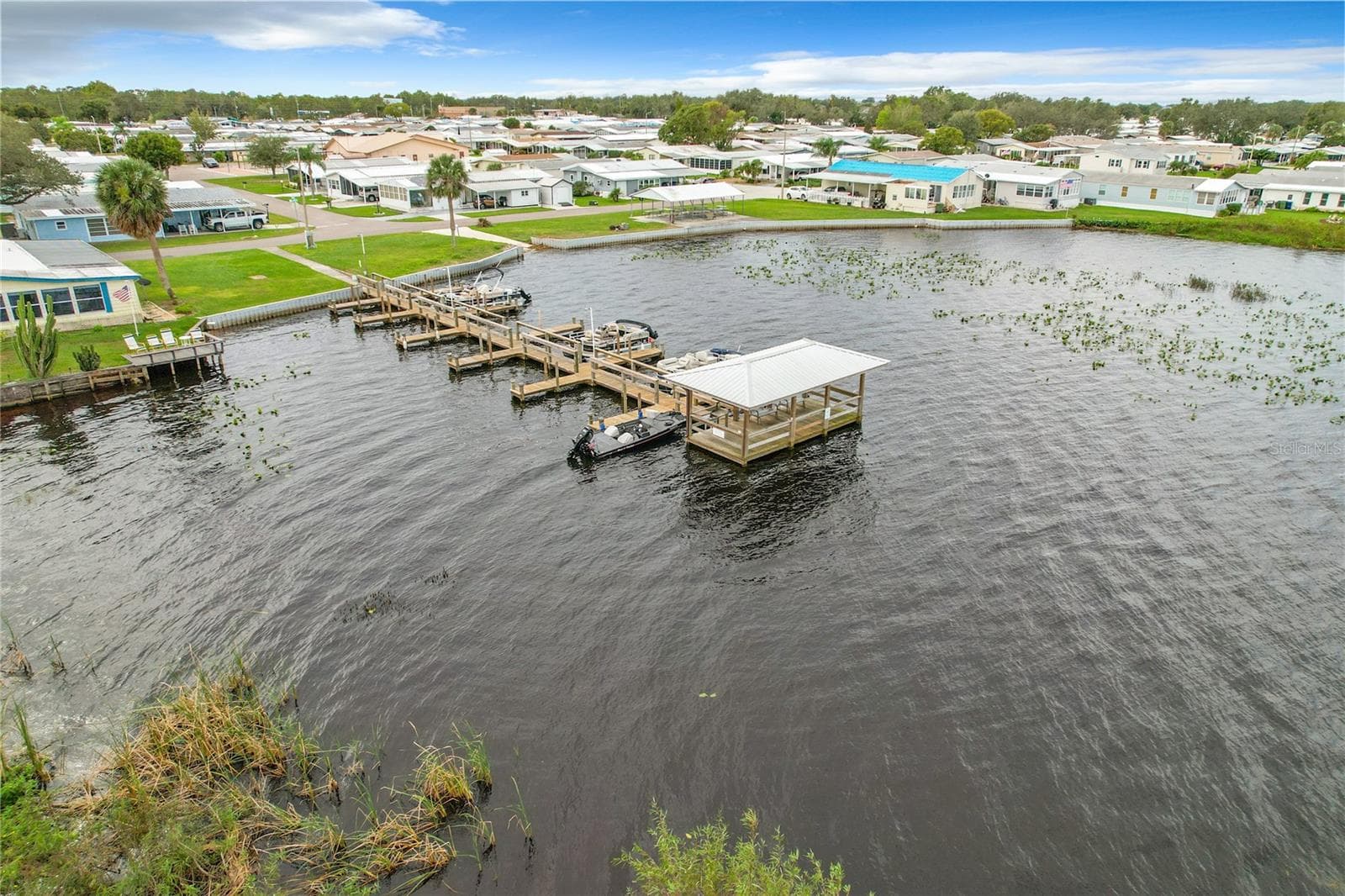 Aerial of the community fishing pier and boat slips - 6825 S LAKE HENRY DR NE, WINTER HAVEN