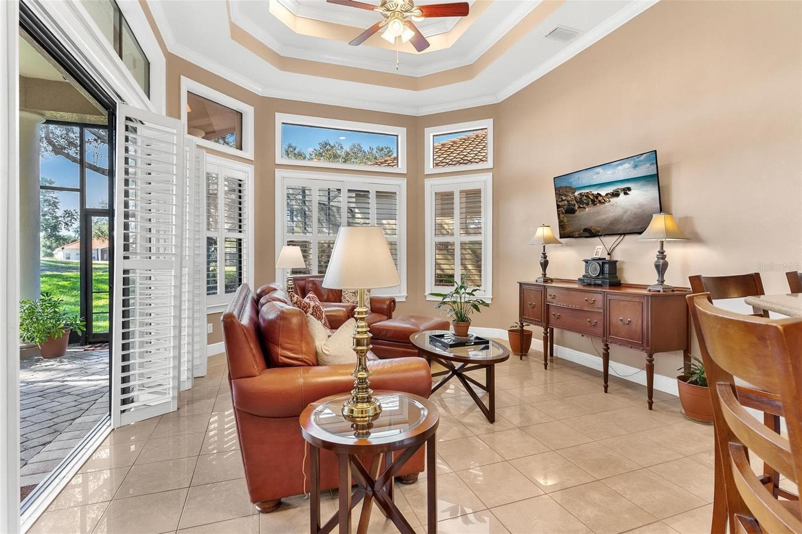 Family Room with custom plantation window treatments... - 26309 SAN GABRIEL, HOWEY IN THE HILLS