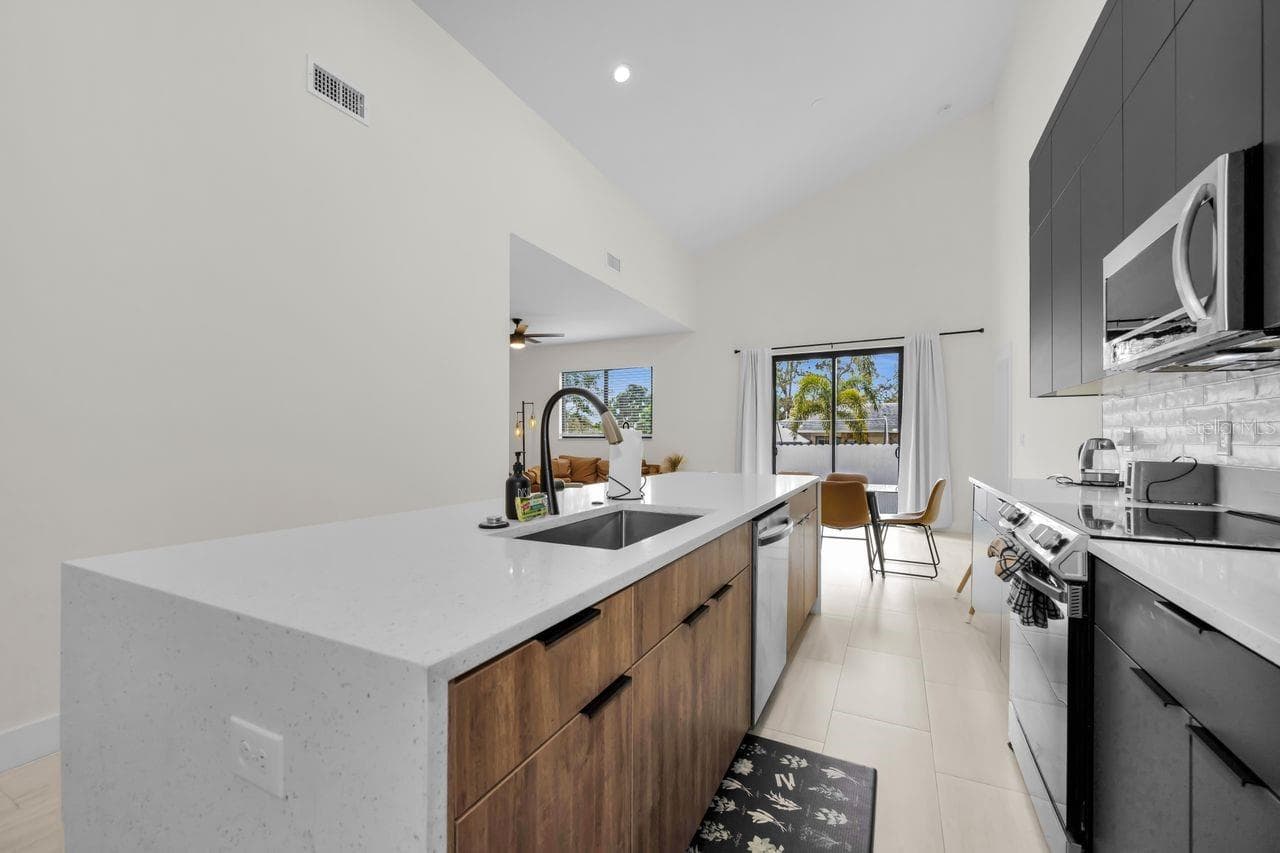 Kitchen boasts an amazing island with a solid surface waterfall edge - 1590 S WASHINGTON AVE, CLEARWATER