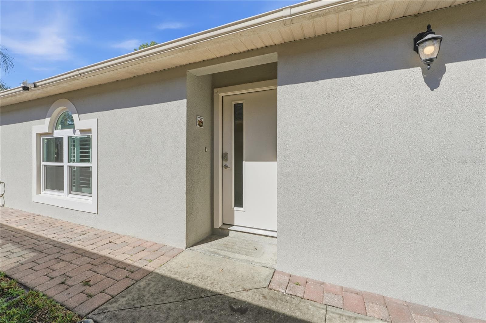 The side walkway and rear patio feature brick pavers, adding both curb appeal and functional surface coverage. - 139 PLACID WOODS CT, SANFORD