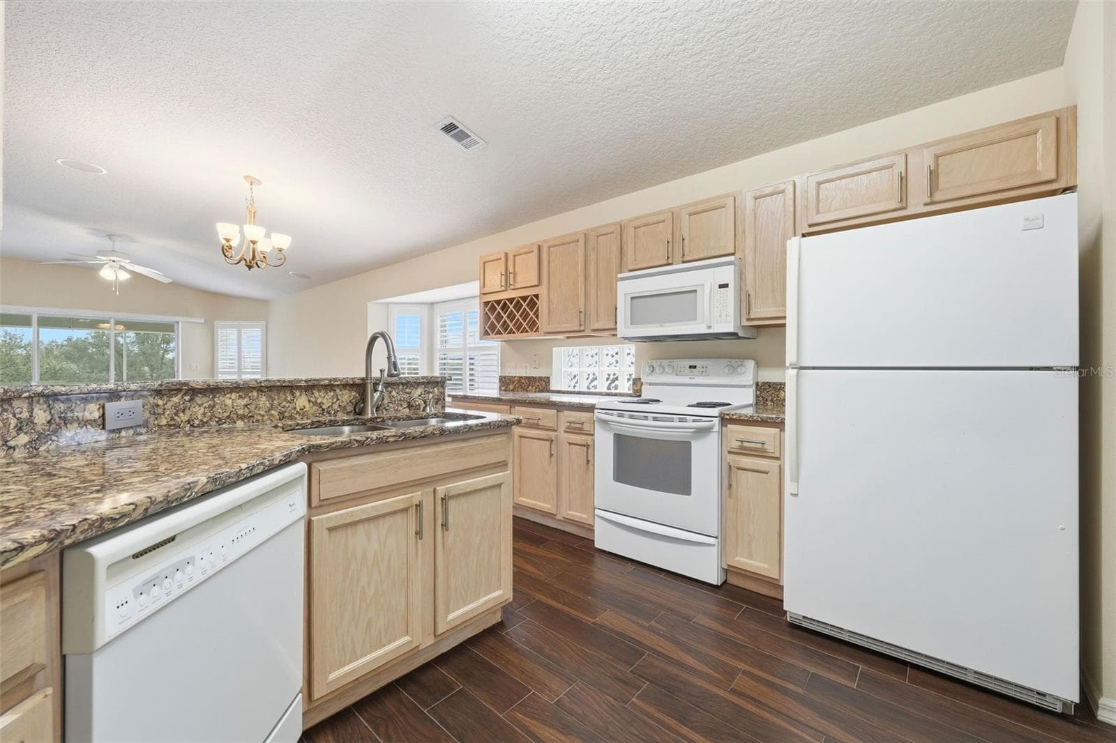 Plenty of cabinet space, Solid Surface Countertops, built-in wine rack and open to great room and golf course view! - 2311 N ANDREA PT, LECANTO