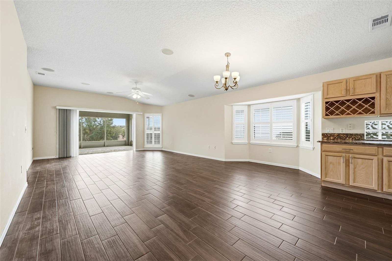 Dining area with bay windows...plantation shutters...kitchen built-in wine rack! - 2311 N ANDREA PT, LECANTO