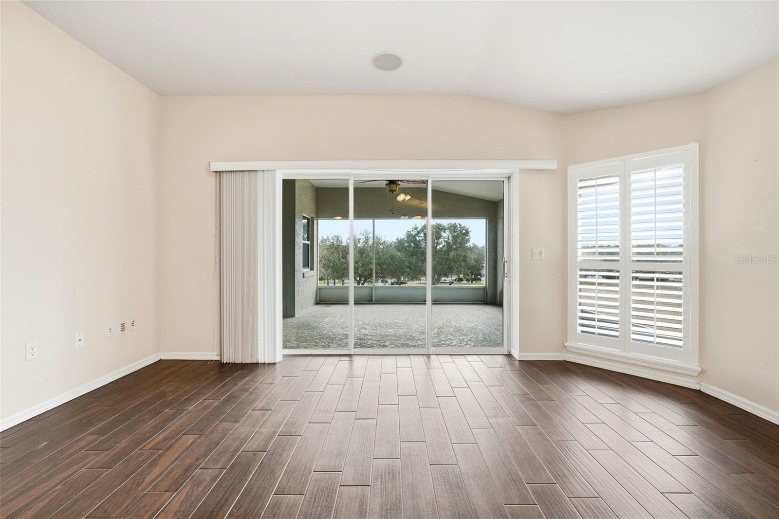 Great Room with plantation shutters and pocket triple sliding doors to lanai with golf course view! - 2311 N ANDREA PT, LECANTO