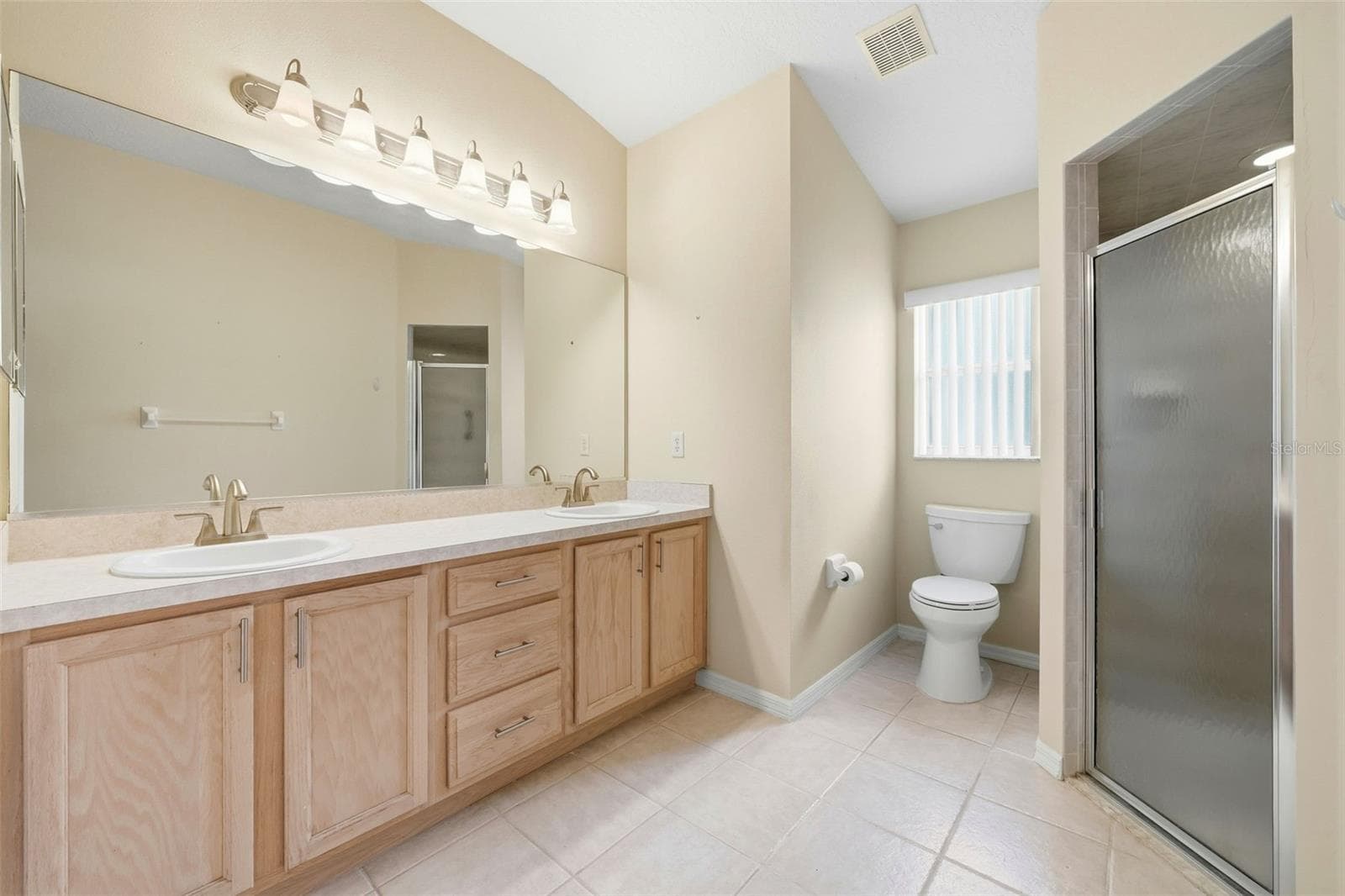 Primary Bathroom with dual sinks, linen and shower - 2311 N ANDREA PT, LECANTO